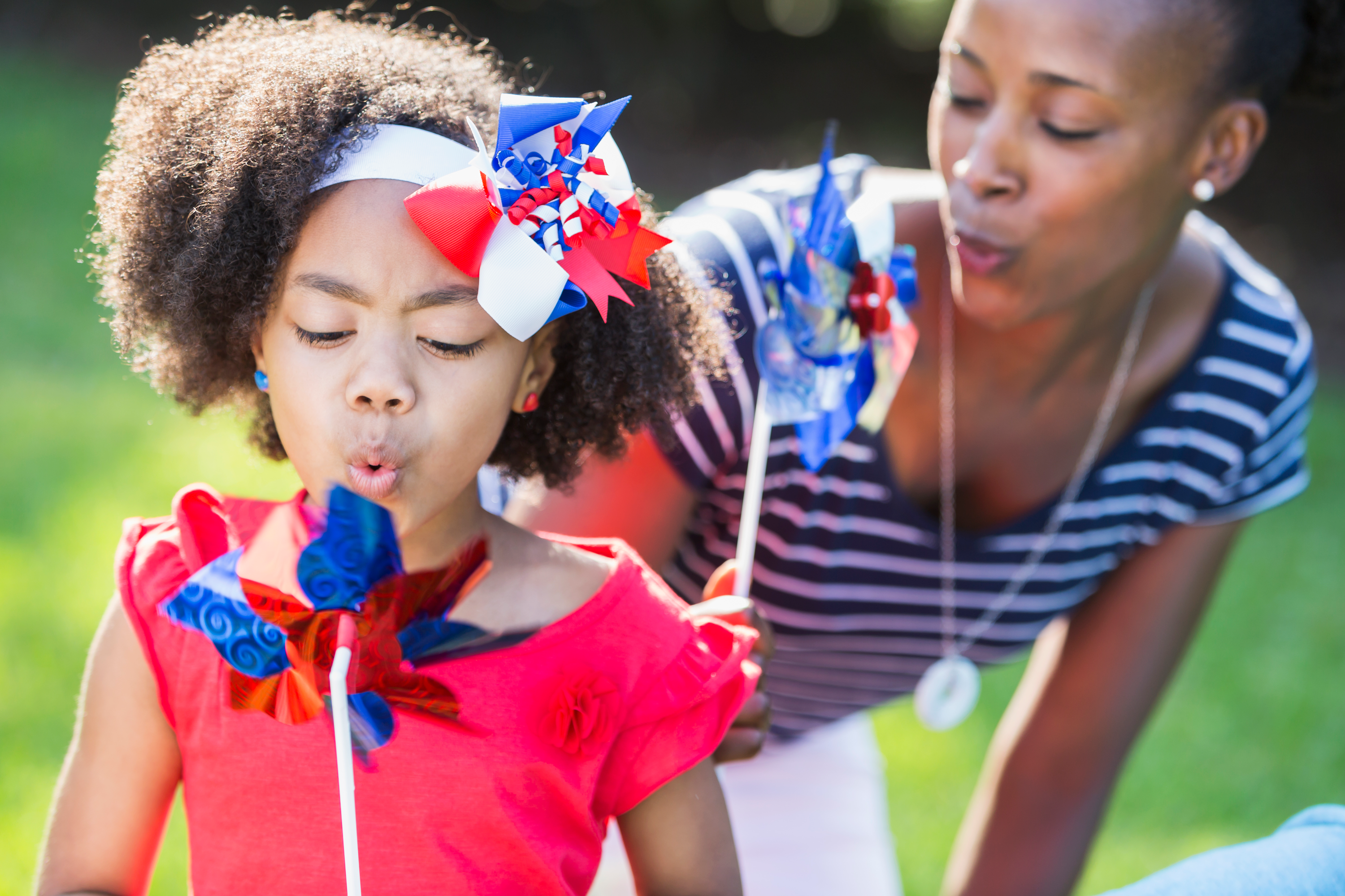 mother and daughter using patriotic pinwheels