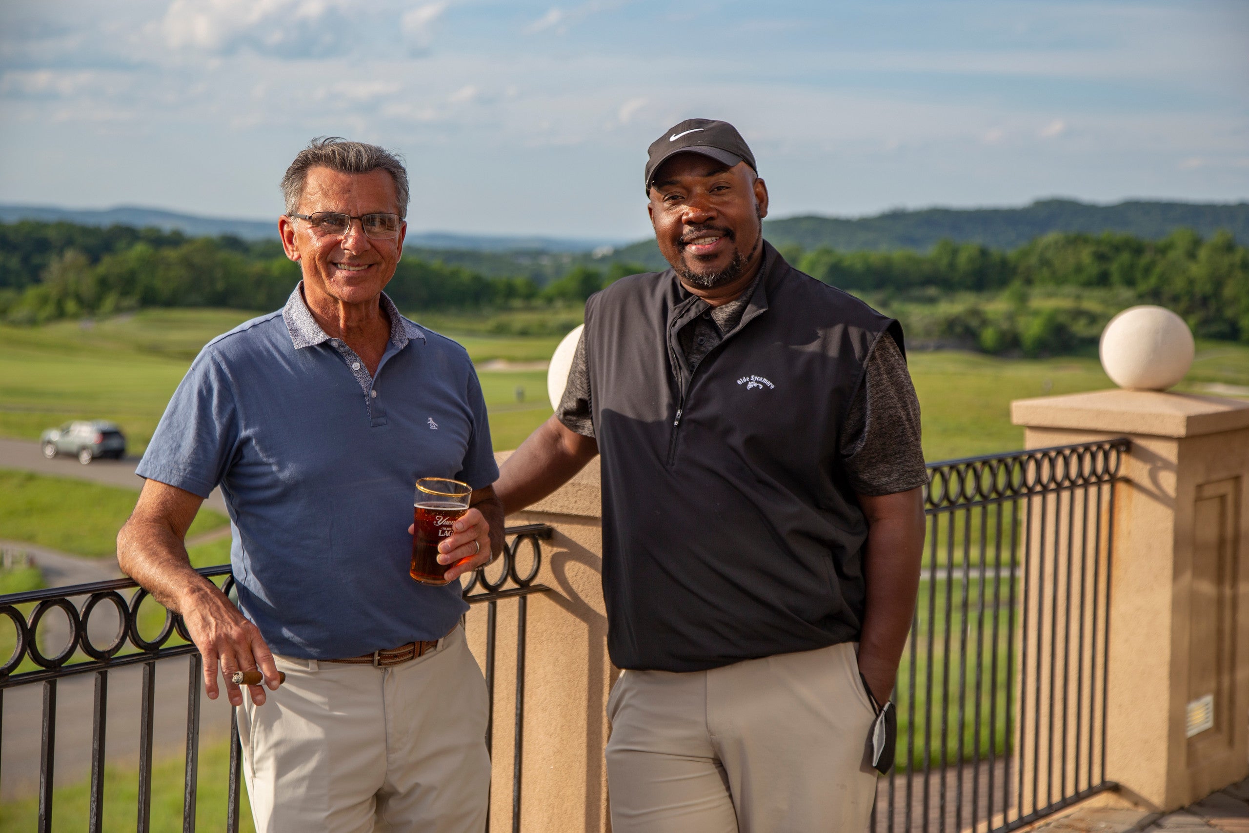 Two guys on the outdoor patio of a golf club at Crystal Springs Resort