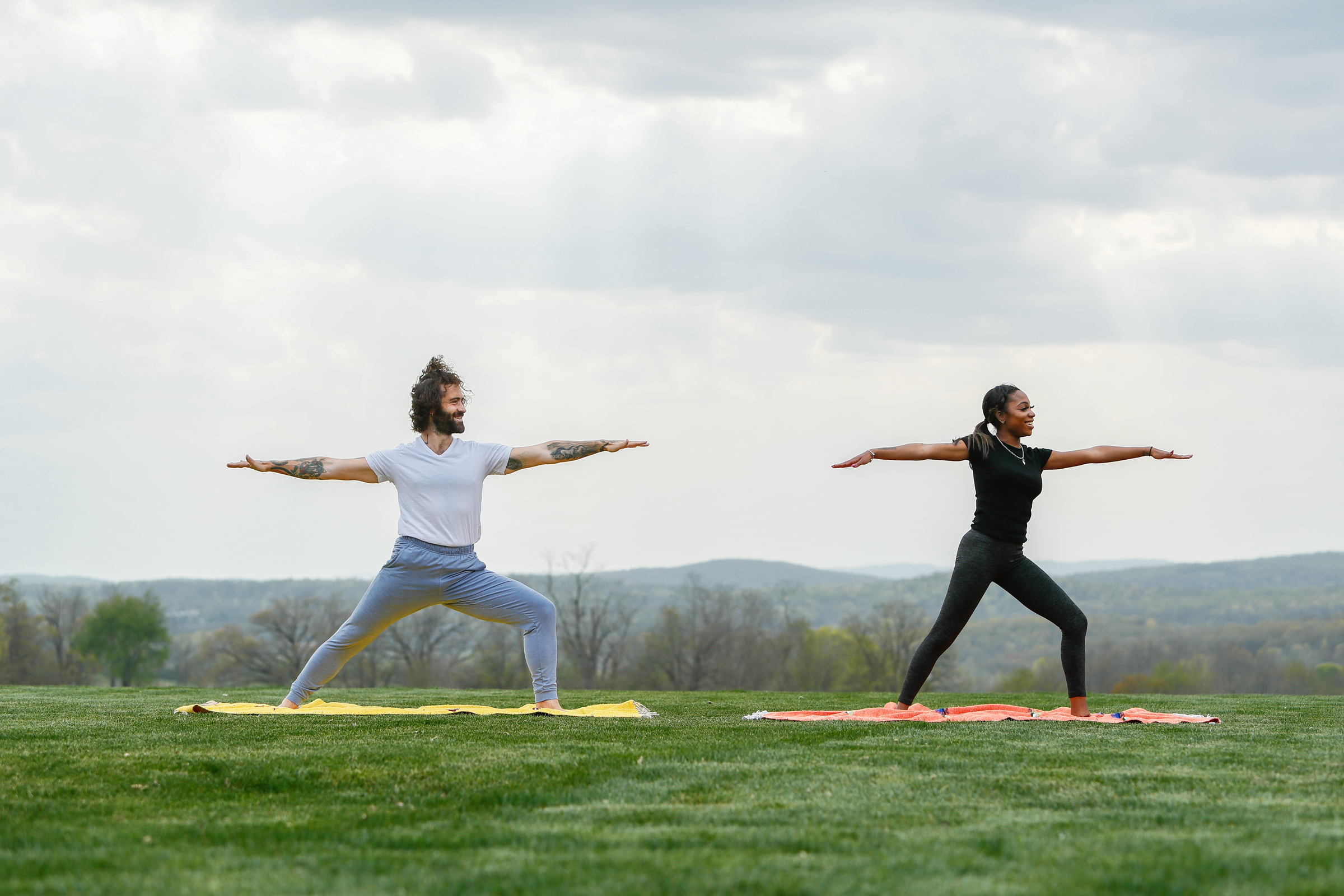 Couple doing warrior yoga pose