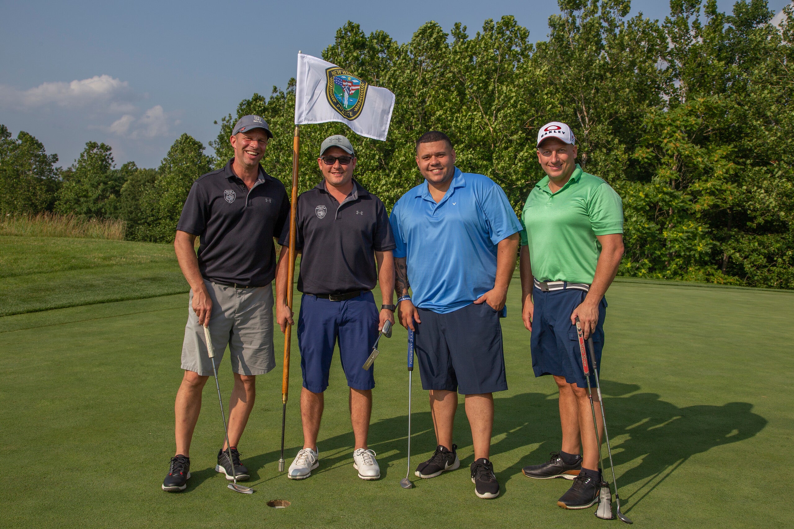 Four guys standing with a law enforcement golf flag at Ballyowen Golf course