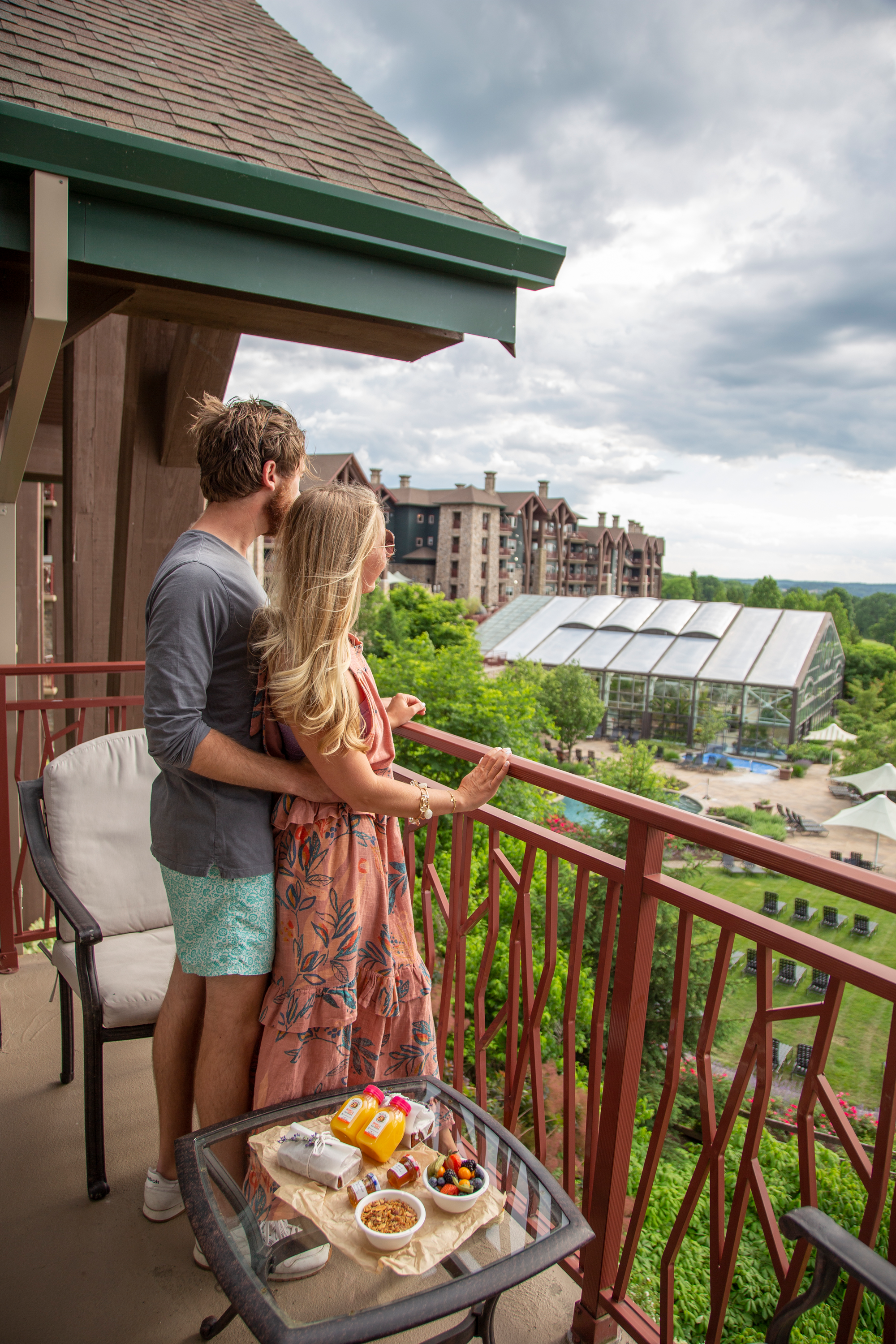 Couple enjoying breakfast while overlooking their balcony view from Grand Cascades Lodge
