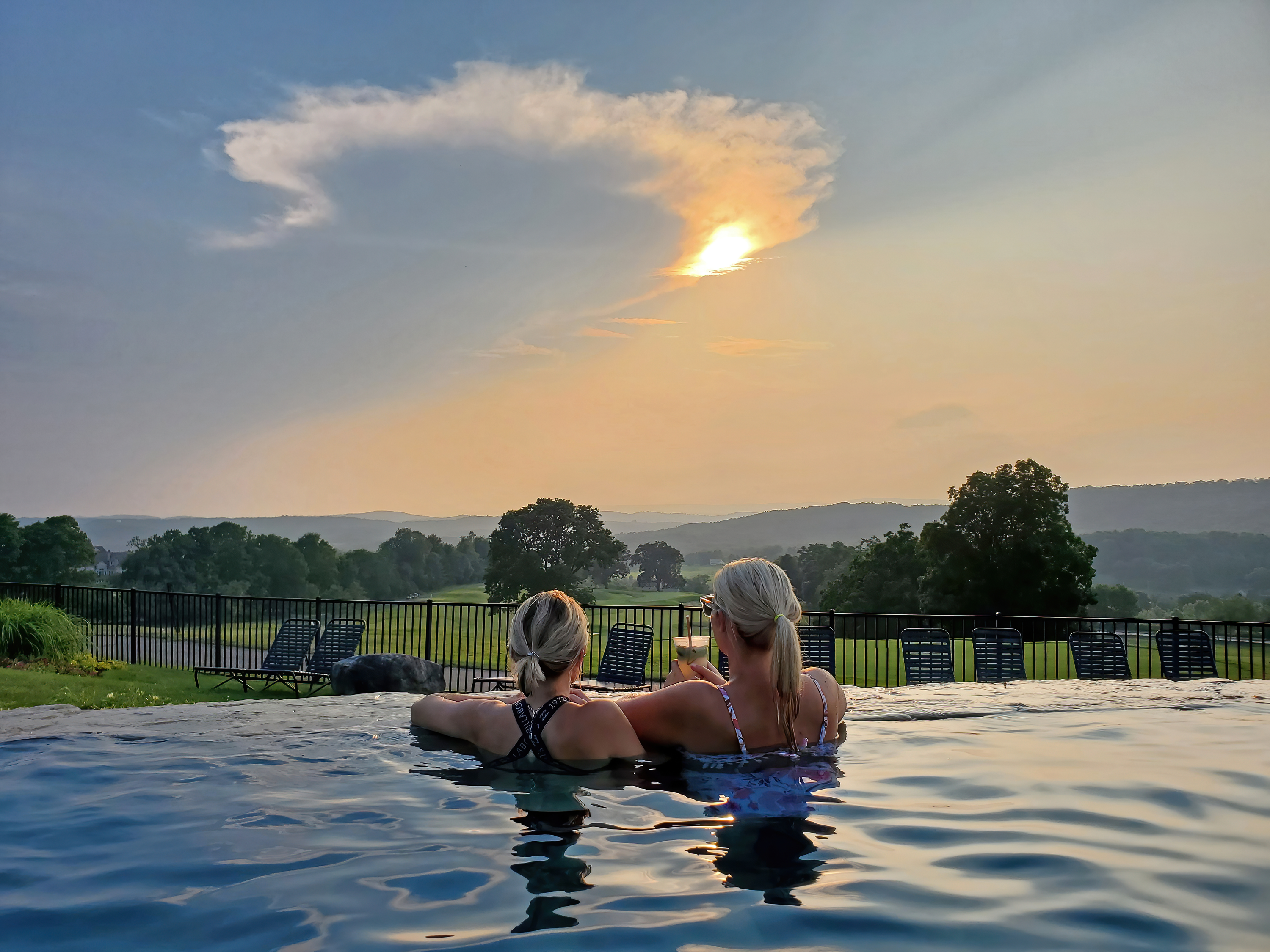Girlfriends enjoying drinks at Vista 180 pool.