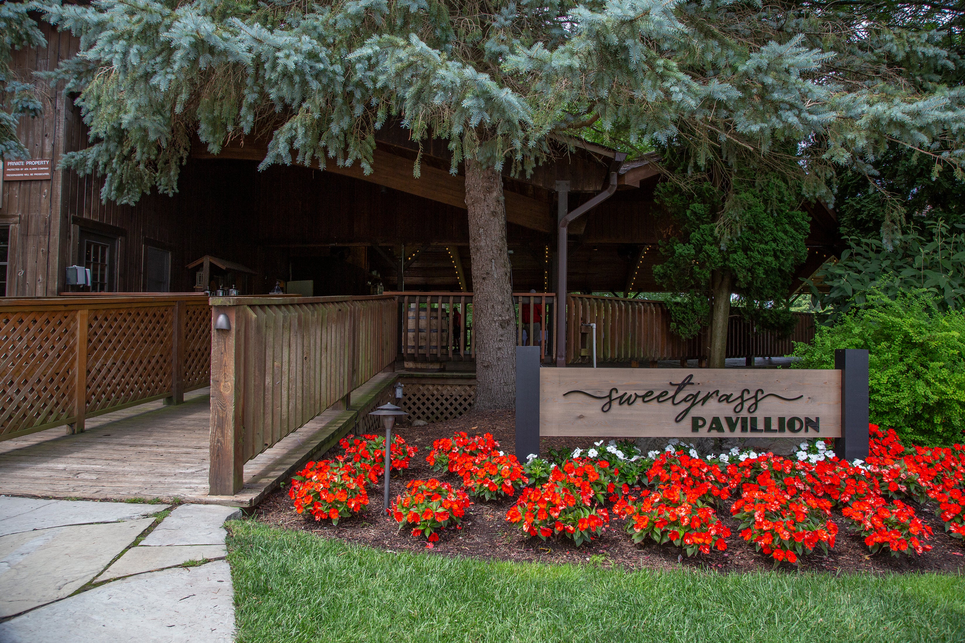 Sweetgrass Pavillion entrance with red flowers