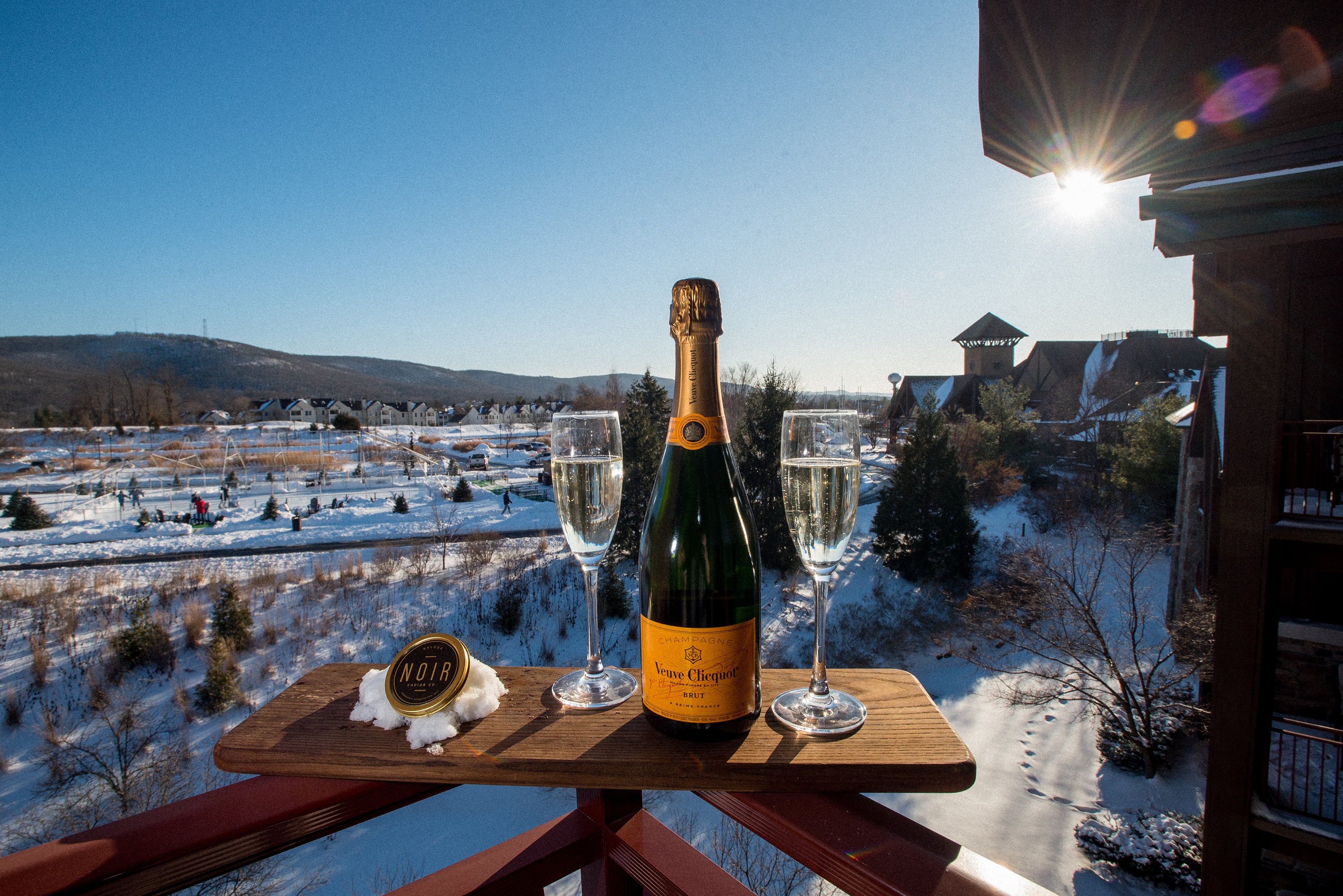 Veuve Clicquot champagne and glasses with sun shining through