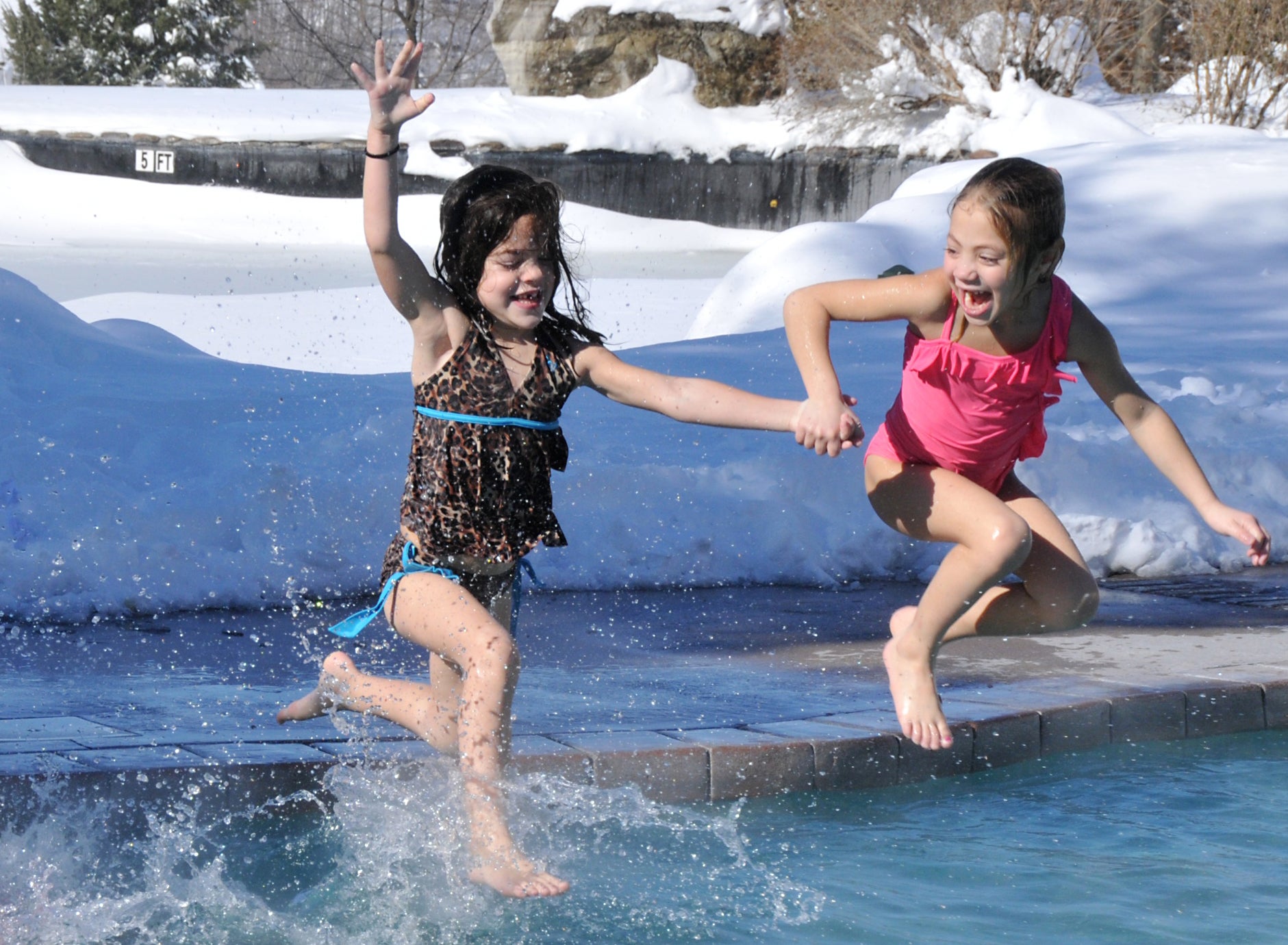 Young girls jumping into the snow pool at Minerals Hotel