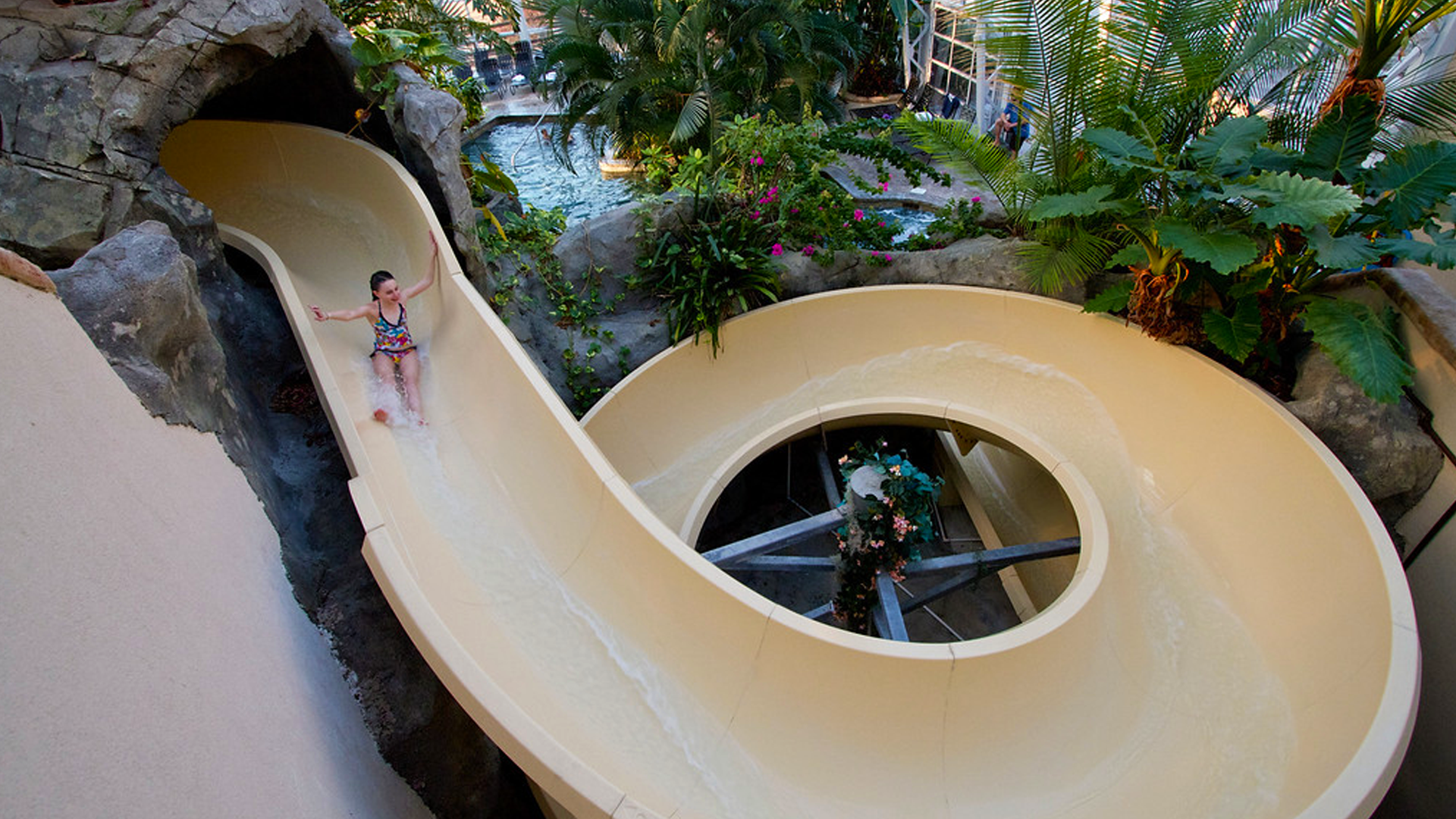 Young girl going down the Biosphere water slide