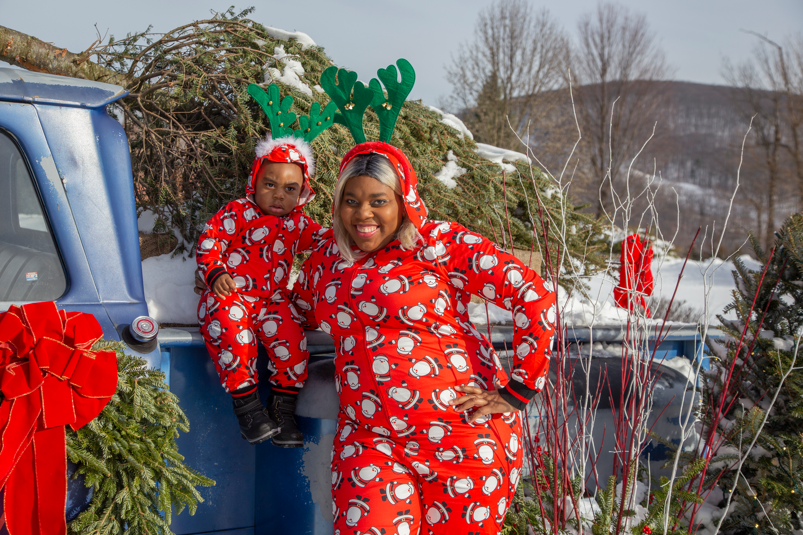 Mother and son in matching Christmas onesies at Grand Cascades Lodge