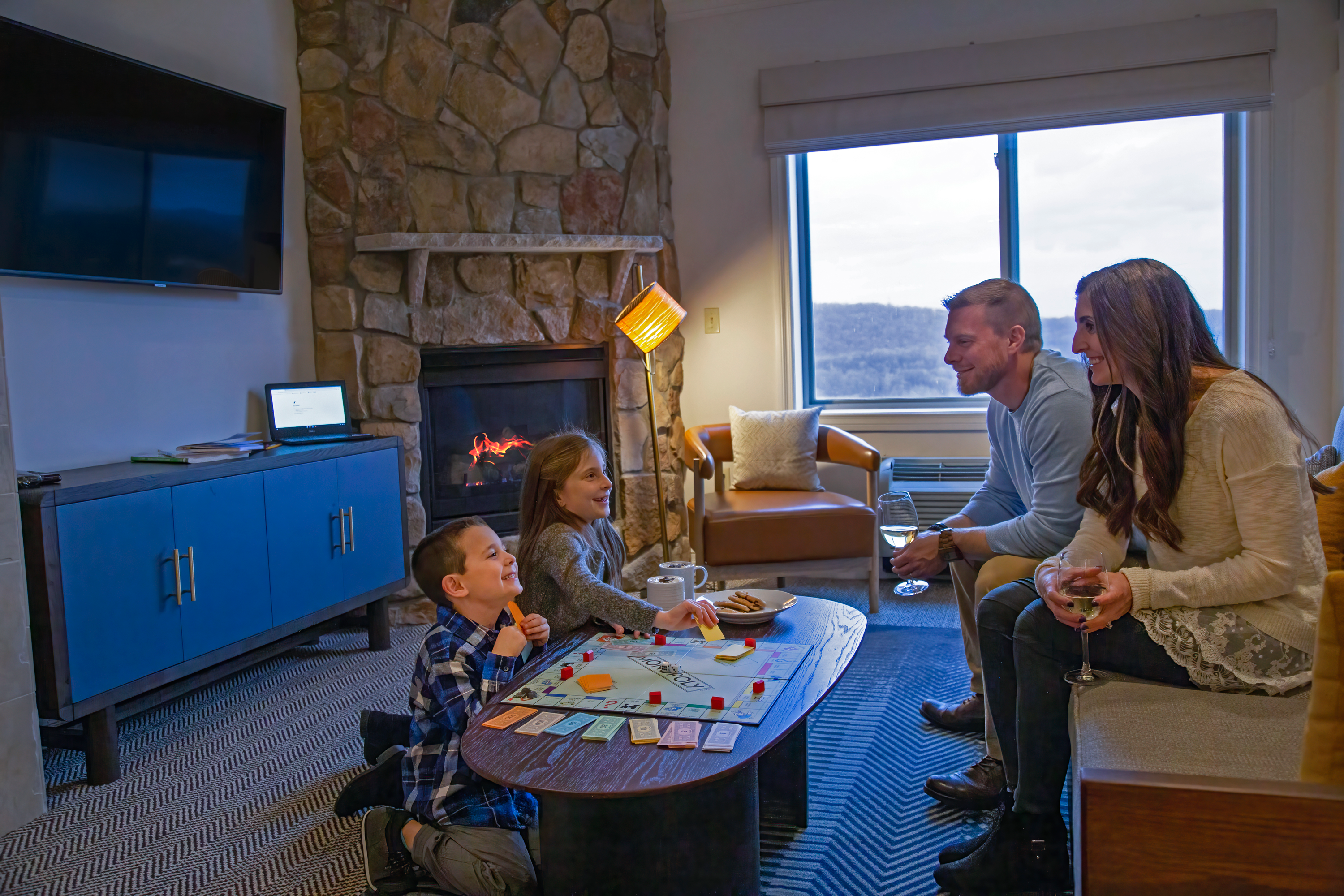 Family playing board game in Grand Cascades Lodge suite