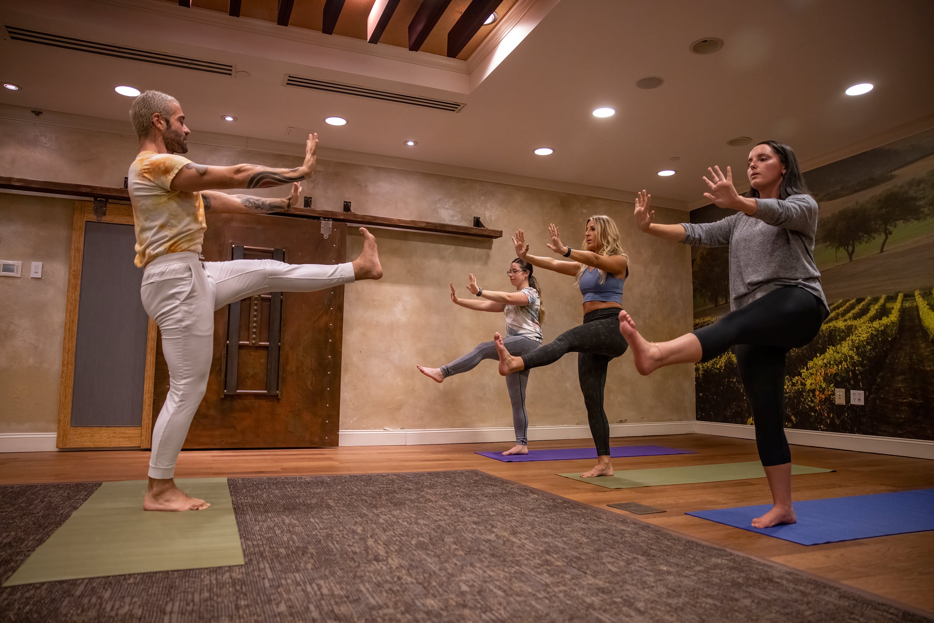 Yoga instructor demonstrating yoga poses to a class at a resort near NYC.