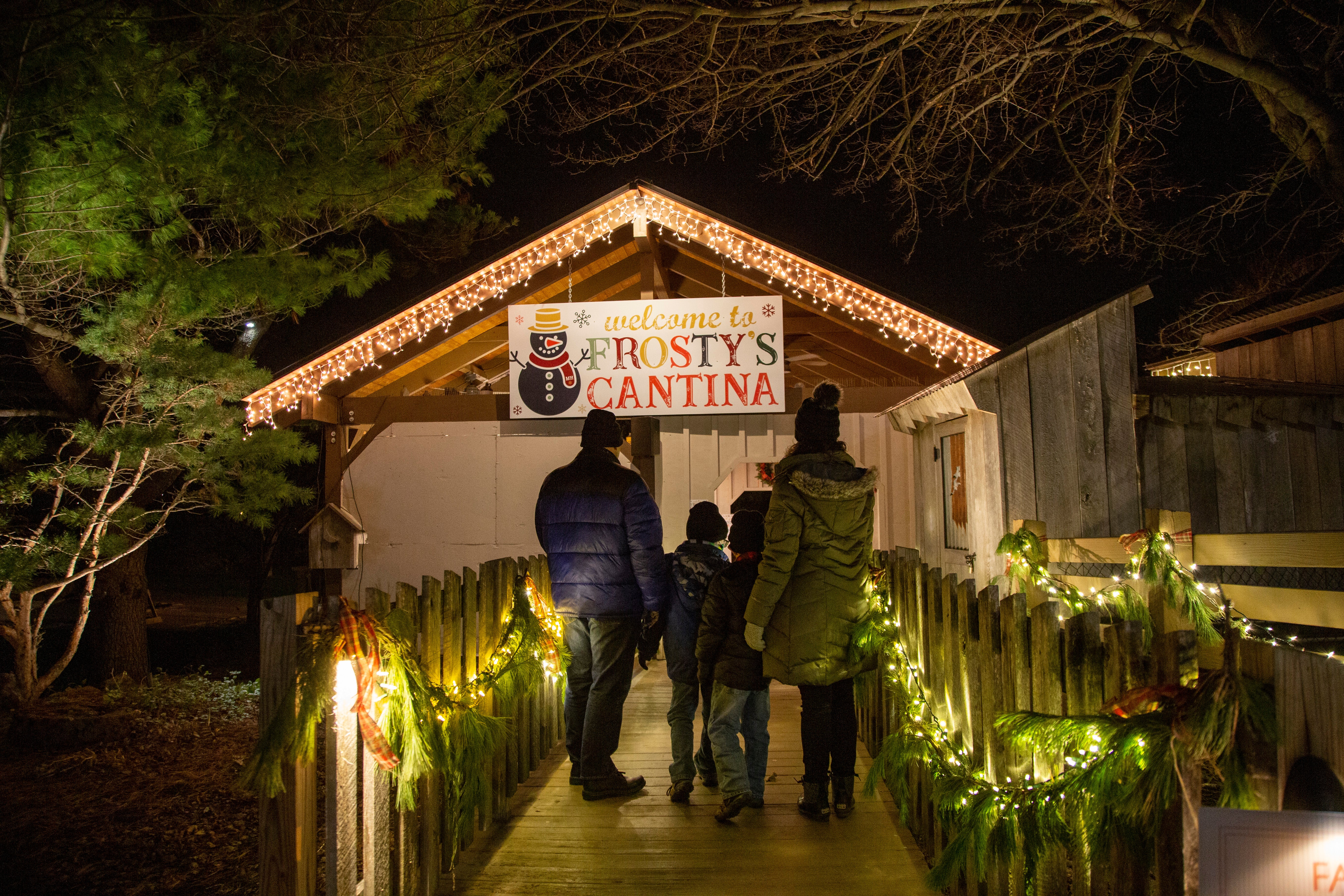 Family standing in front of Frosty's Cantina sign.