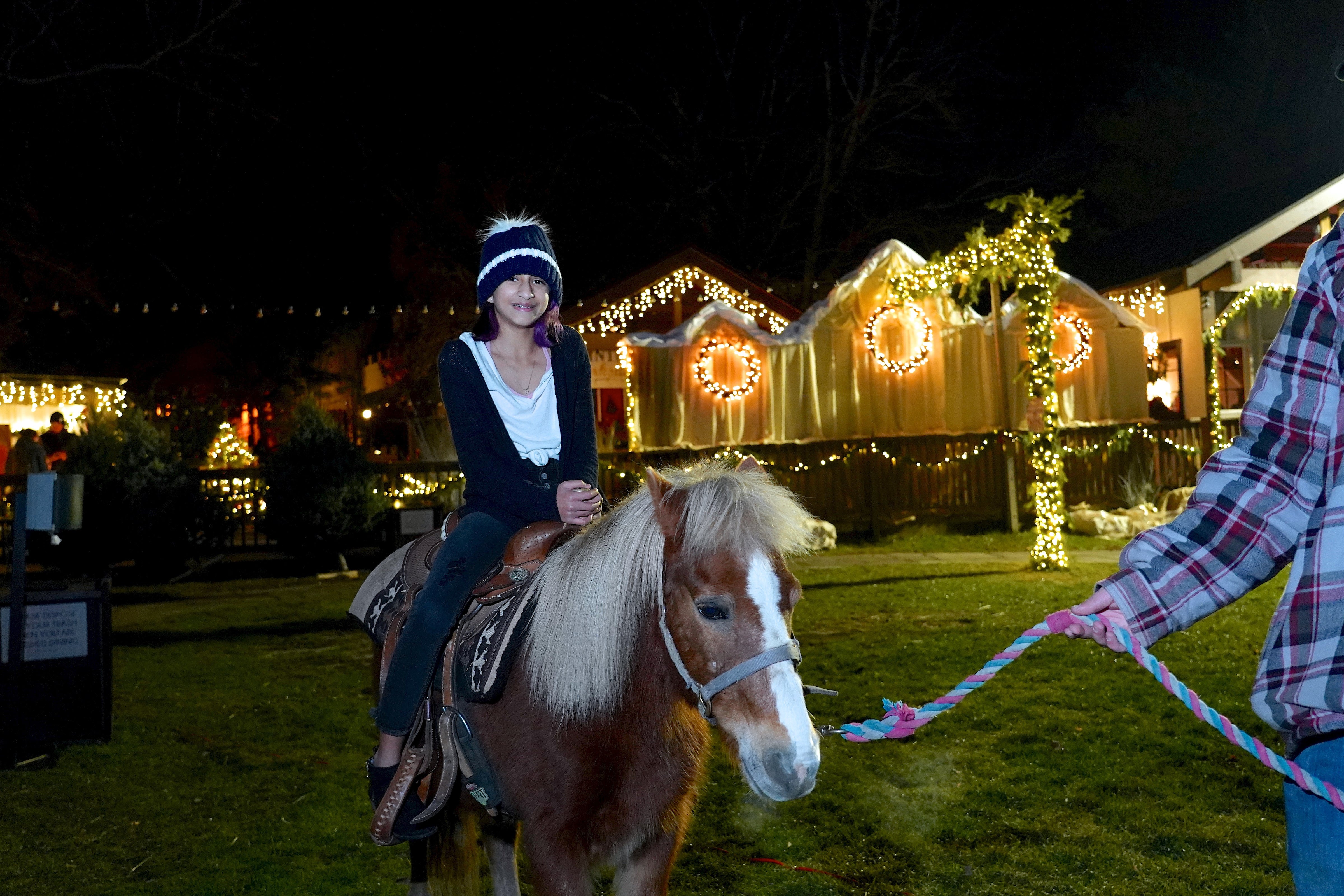 Young child riding pony.