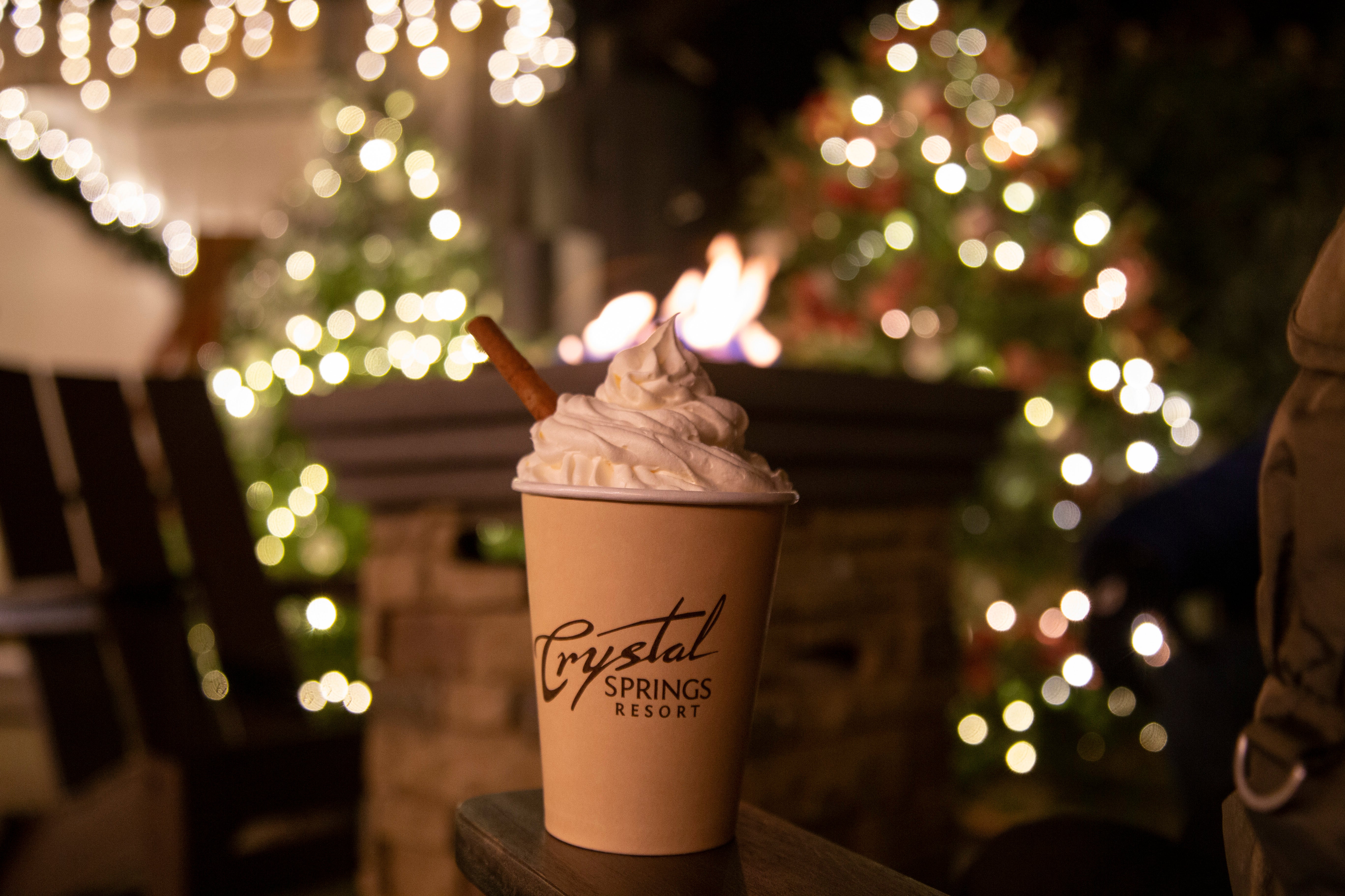 Crystal Springs logo cup with whip cream and cinnamon stick.