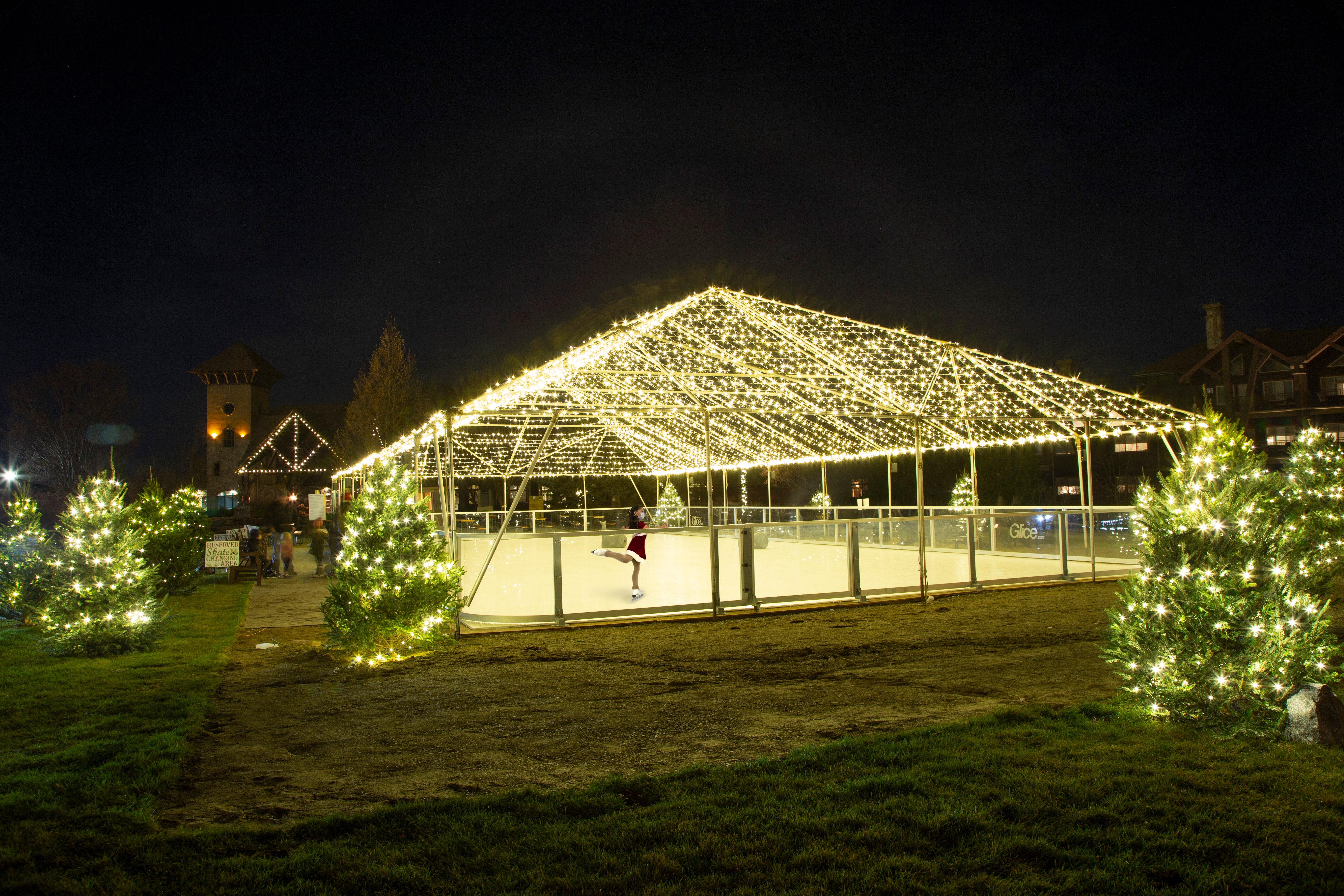 Glice skating rink lit up at night.