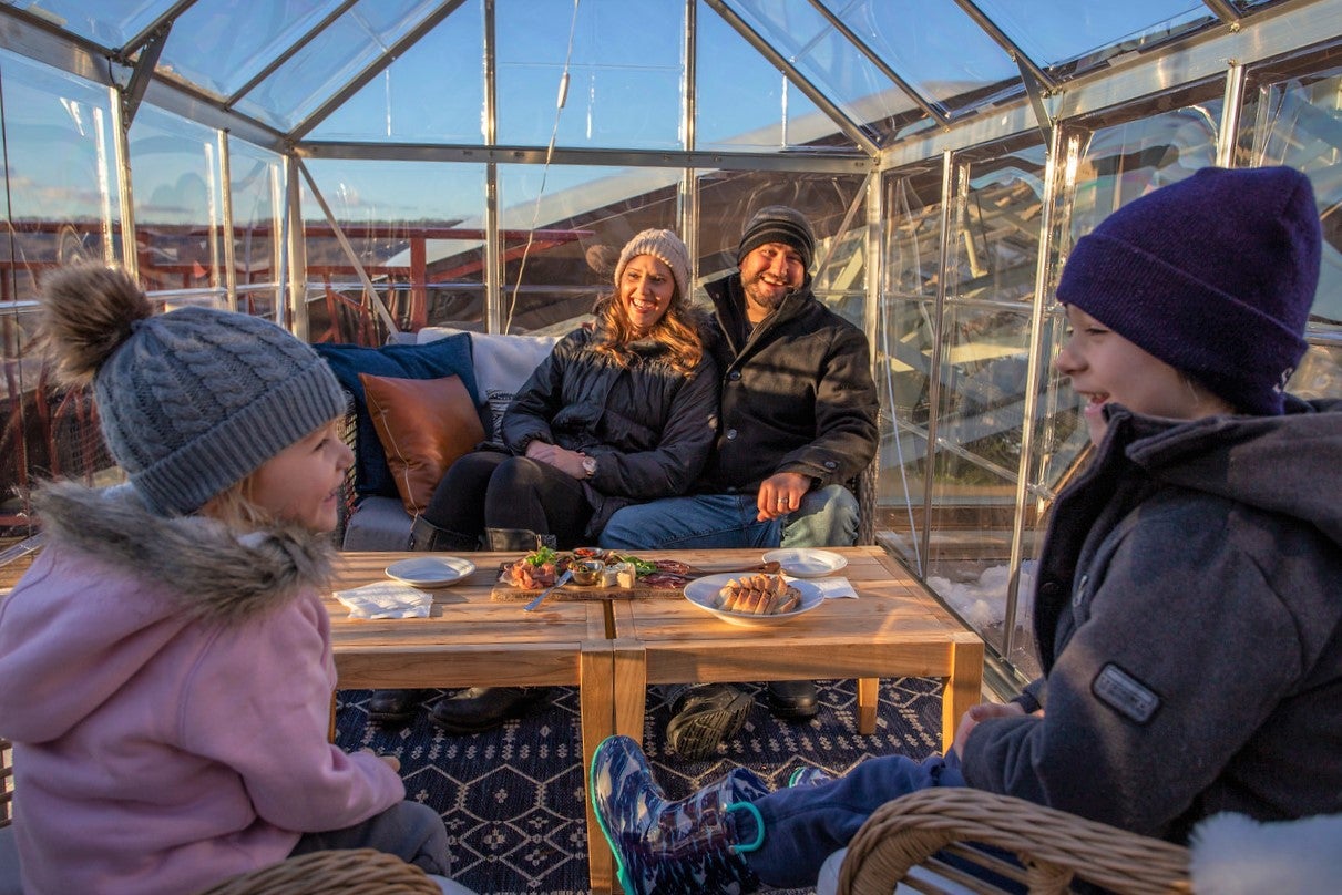 Family in winter clothing sitting in Champagne Chalet