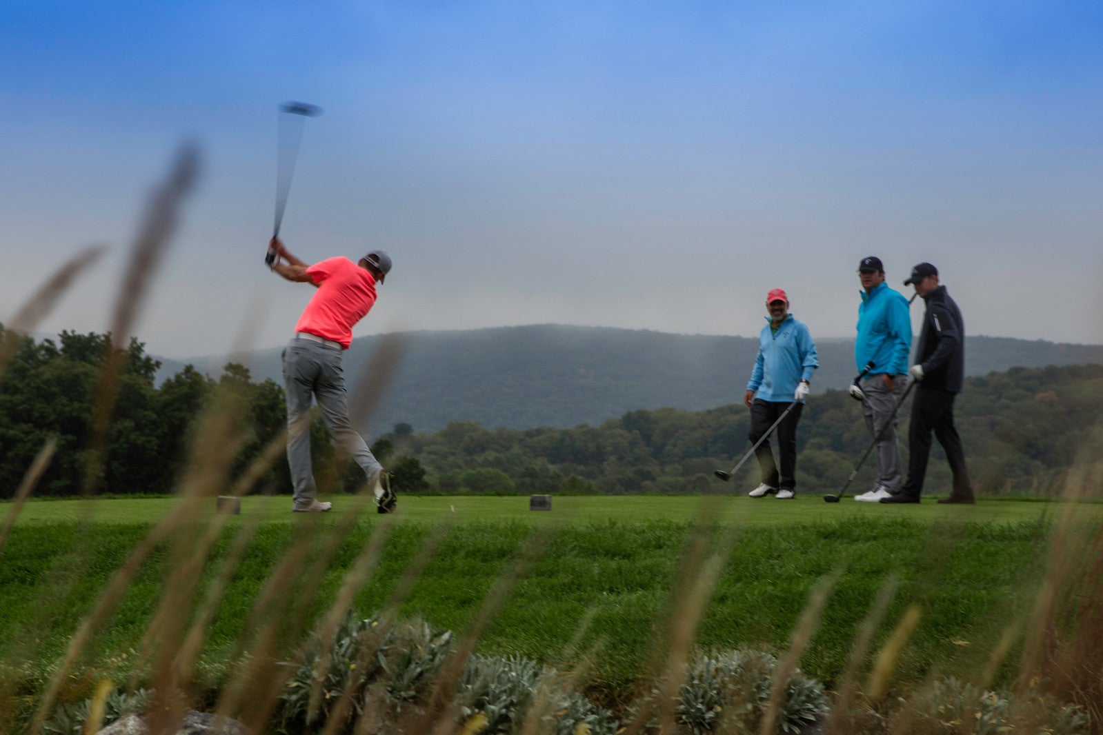 Four men playing golf at a resort near NYC