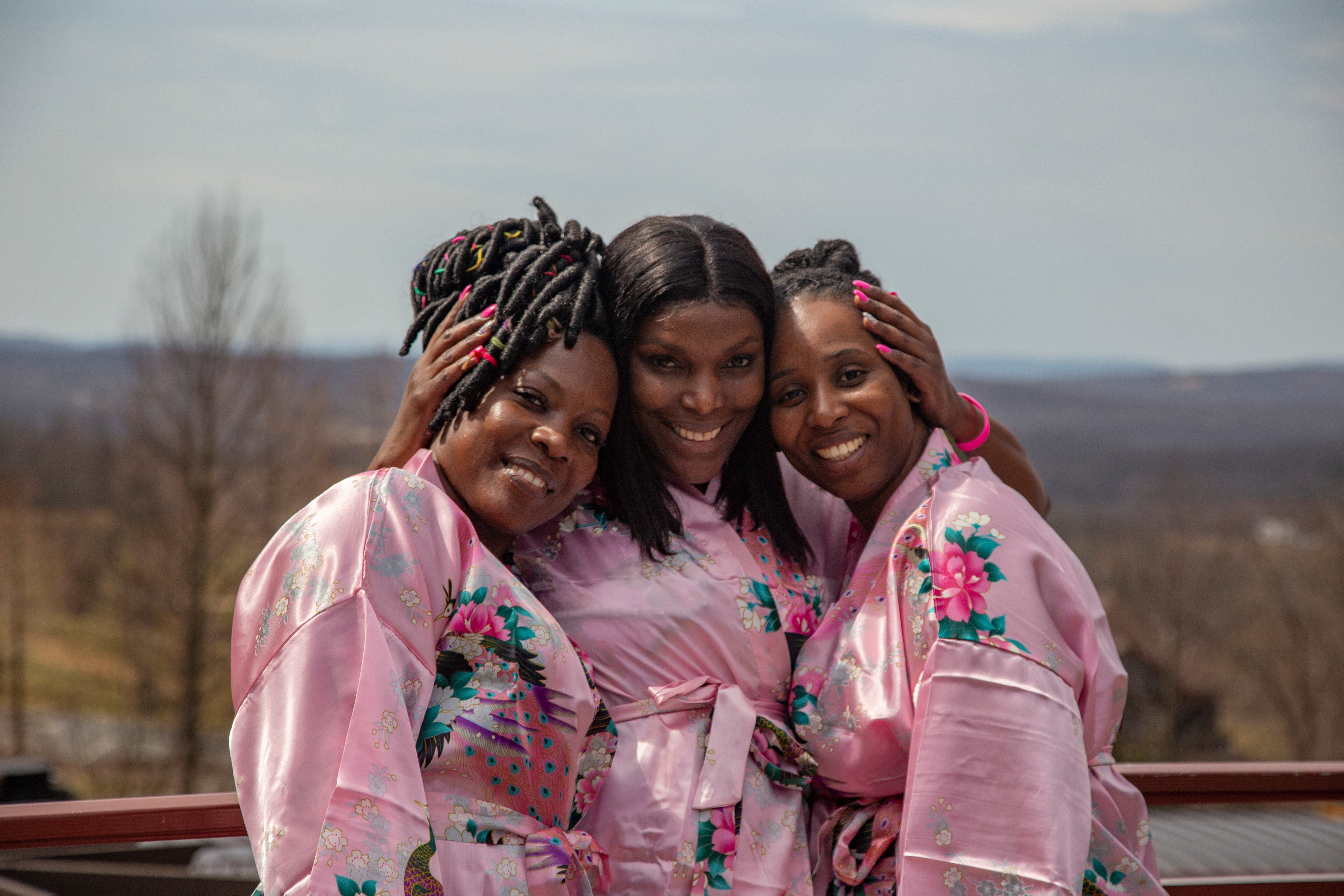 Girlfriends posing with robes