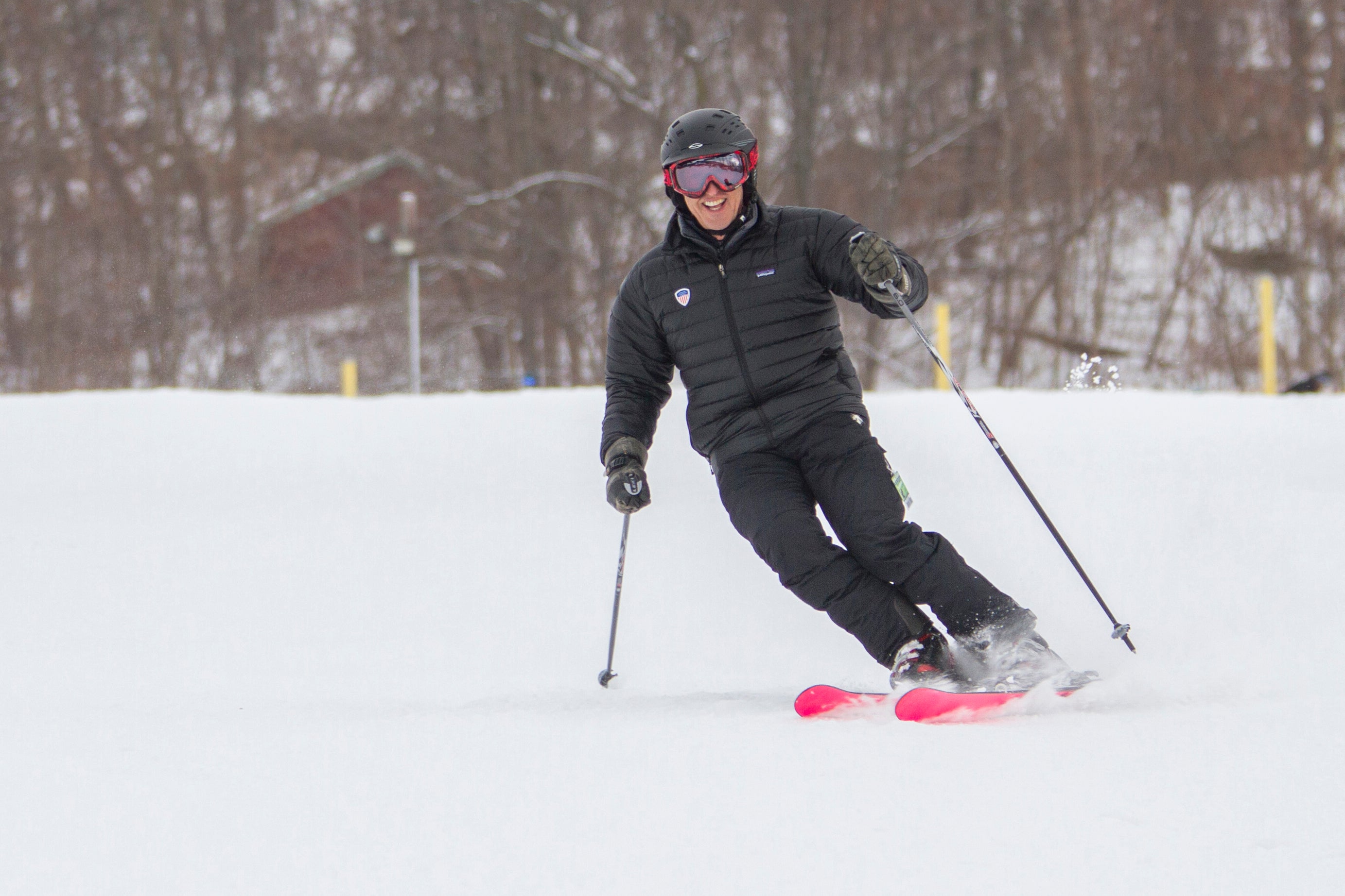 Person in black coat and pants skiing down mountain.