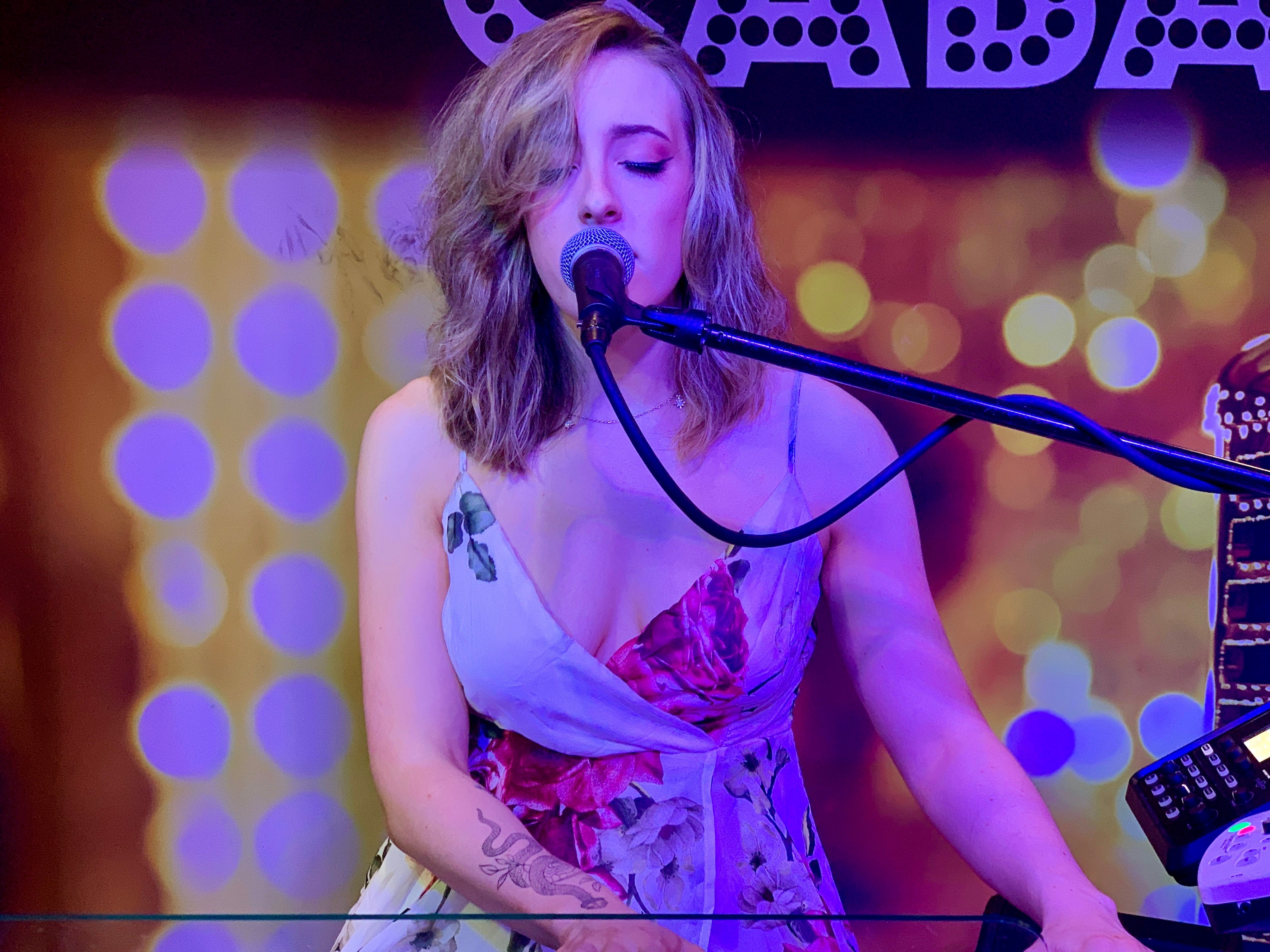 Andie Baldwin singing.