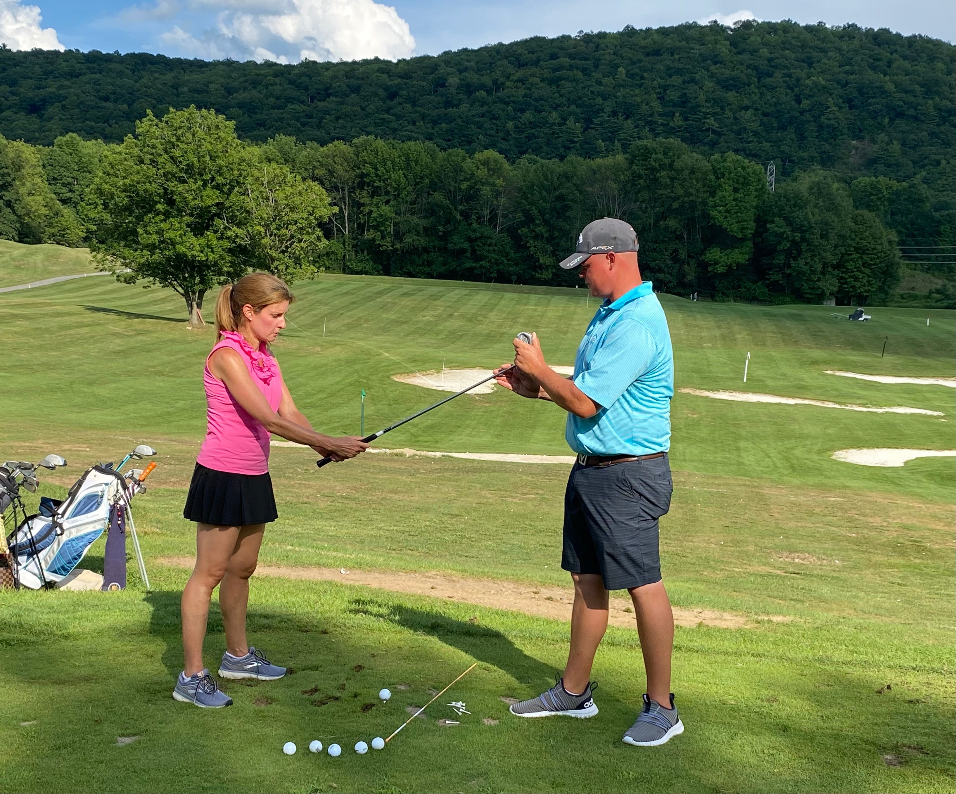 Golf Instructor with Leadbetter Golf Academy teaching woman to golf