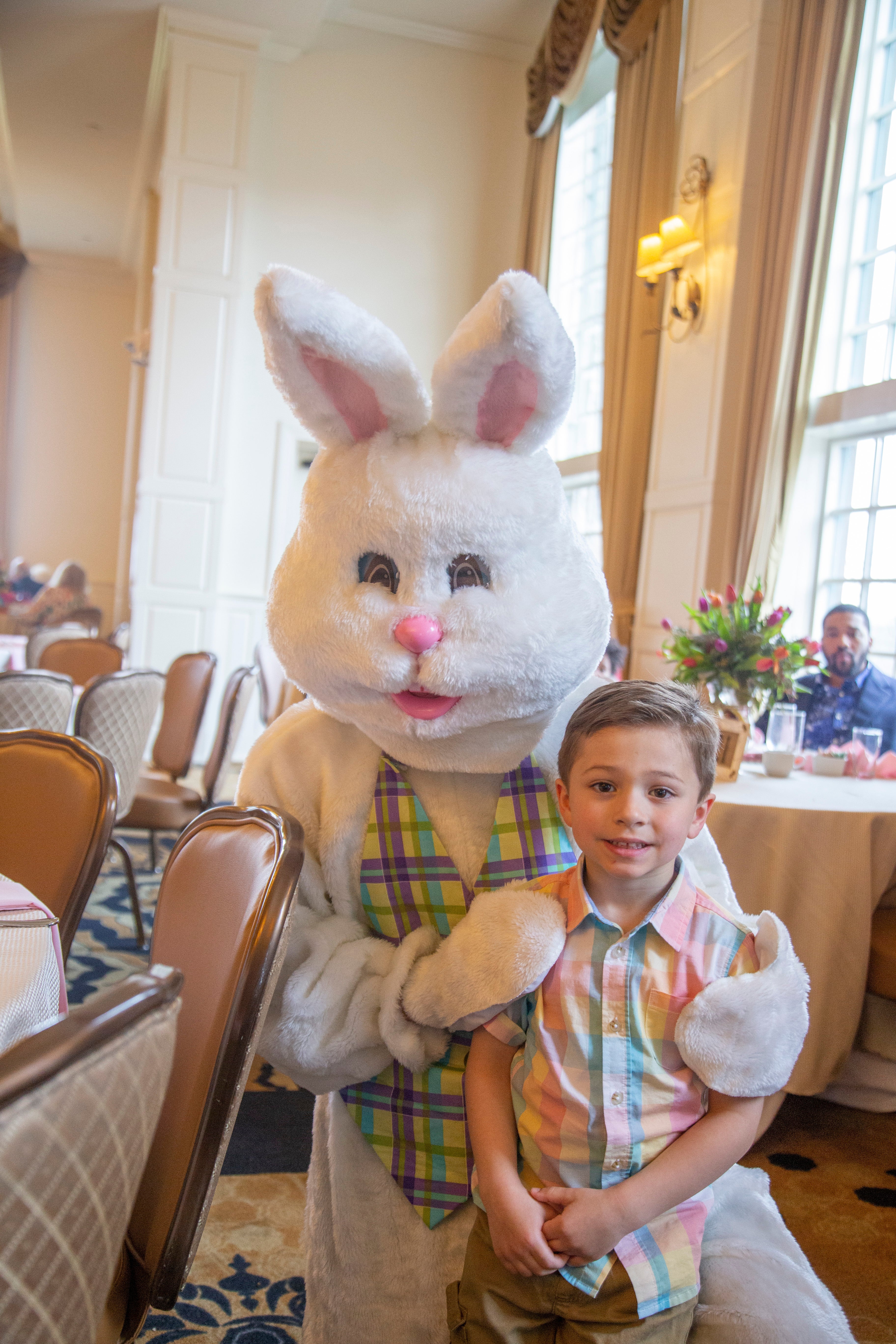 Young boy standing with easter bunny.
