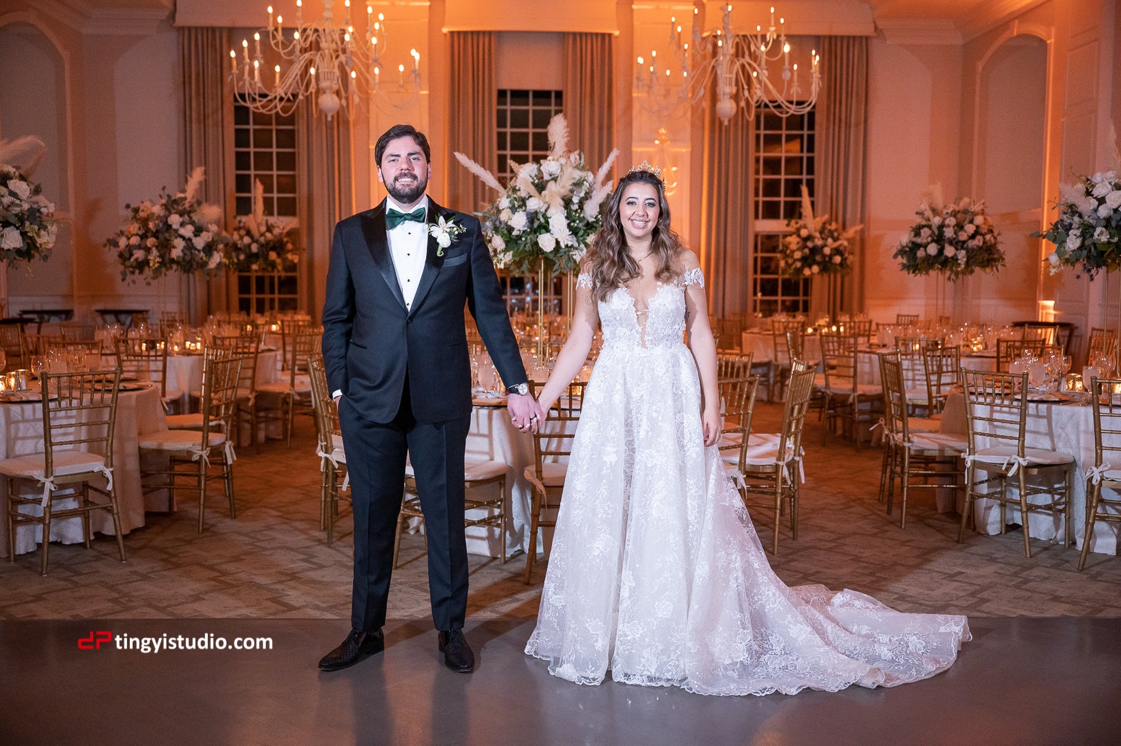 Bride and Groom holding hands in the ballroom at Crystal Springs Resort