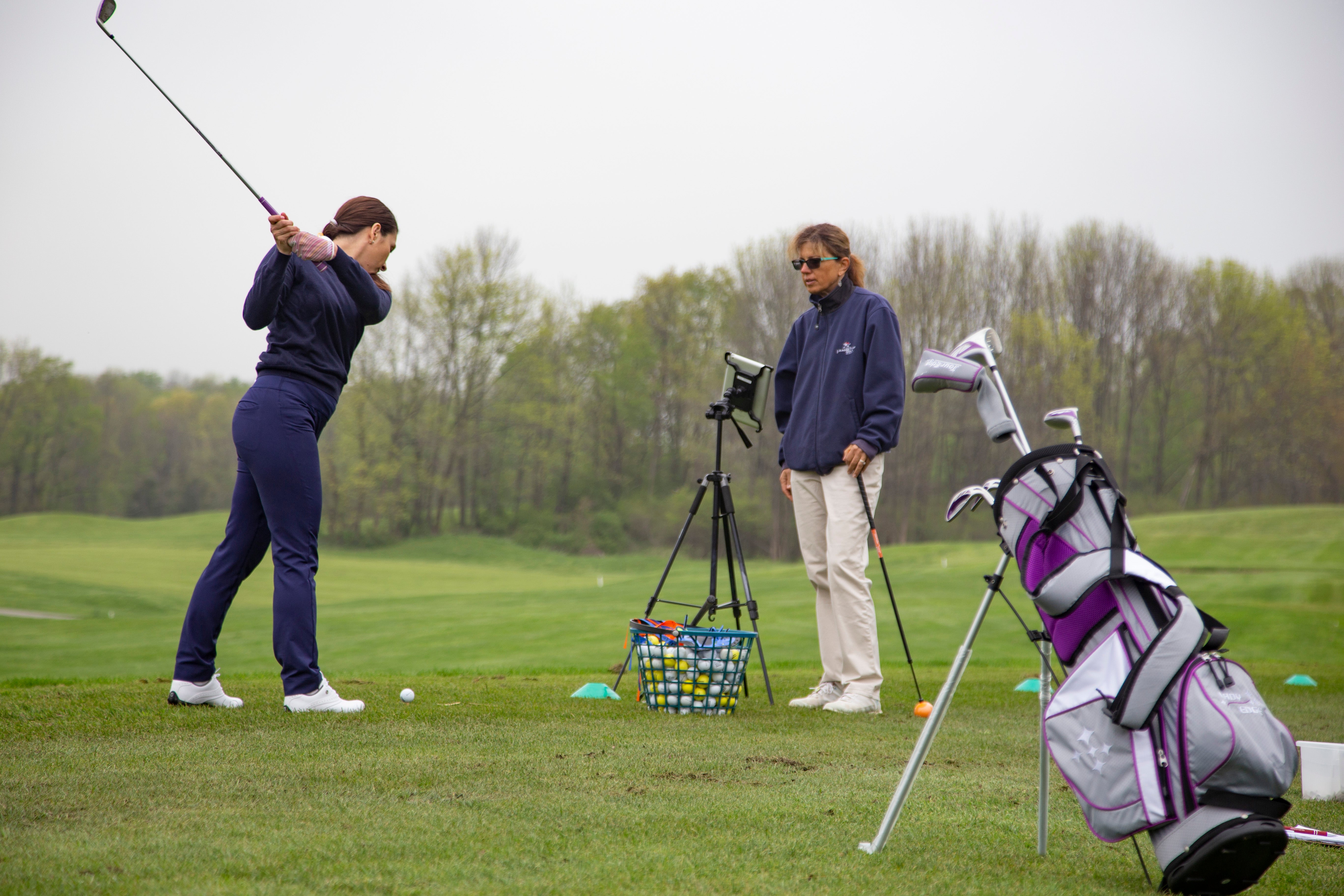 Young girl learning to golf by an instructor at the Leadbetter Golf Academy at Crystal Springs Resort