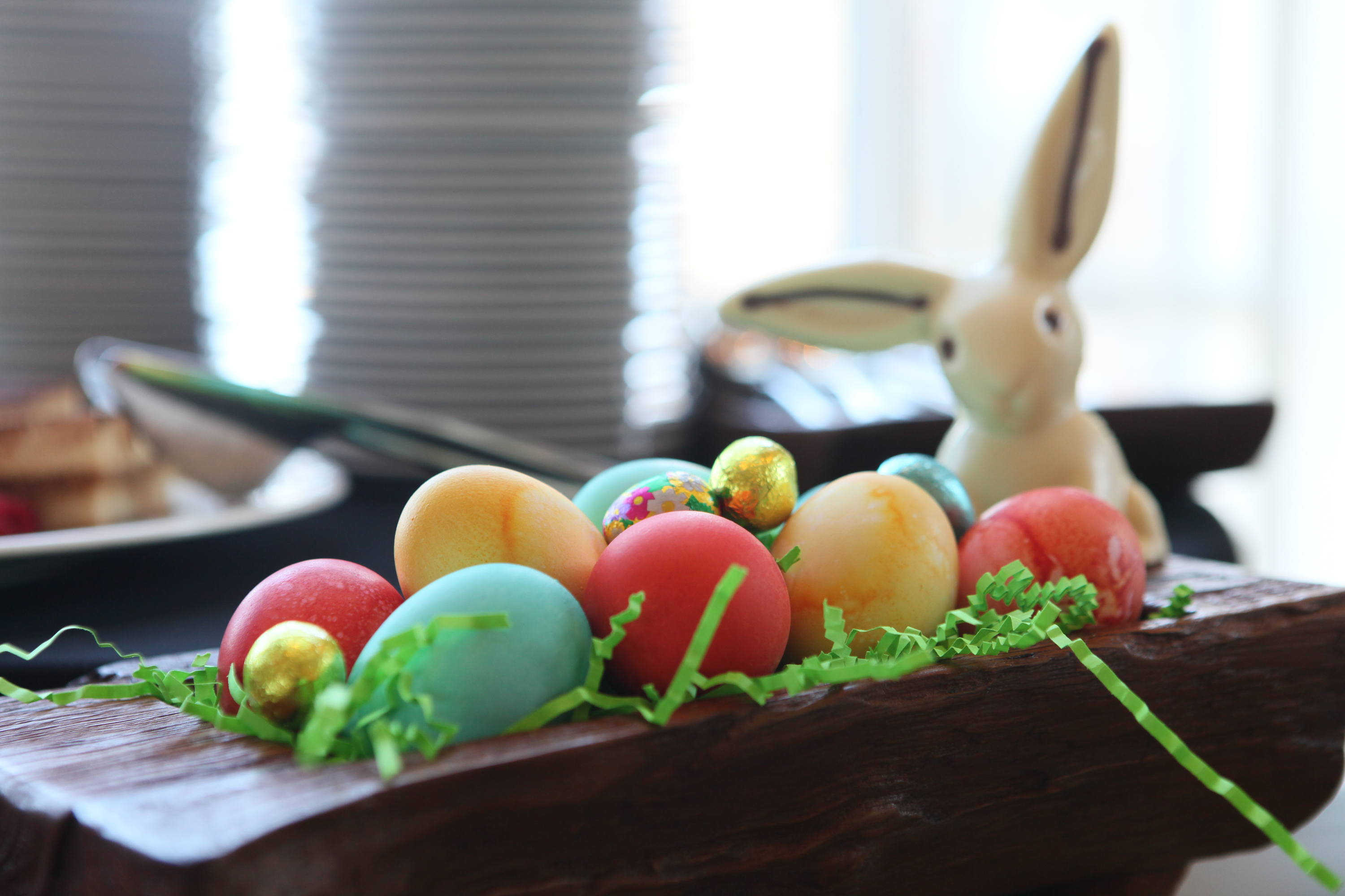 Dyed eggs in wooden basket.