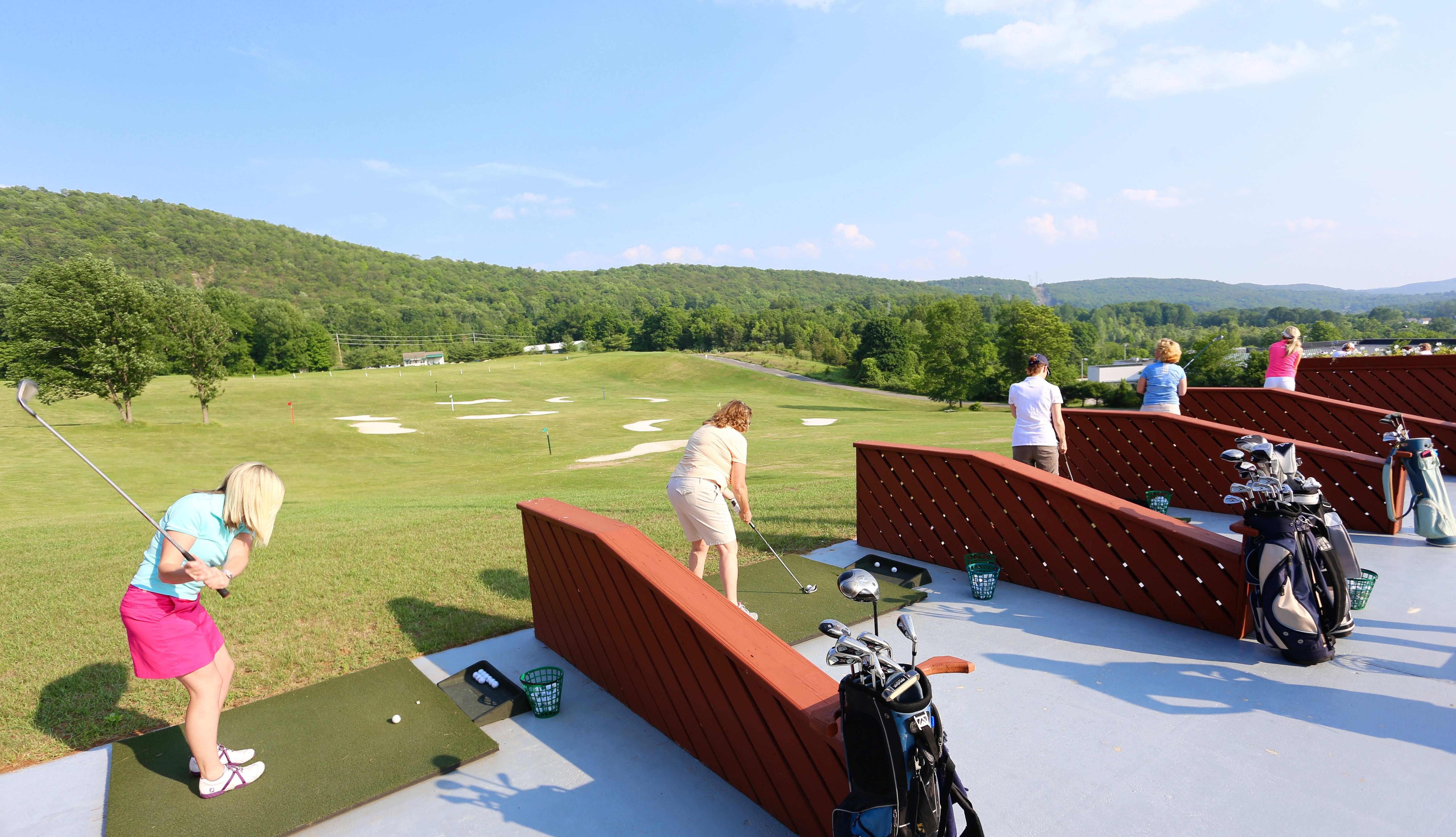 Women golfing at a driving range at Crystal Springs Resort