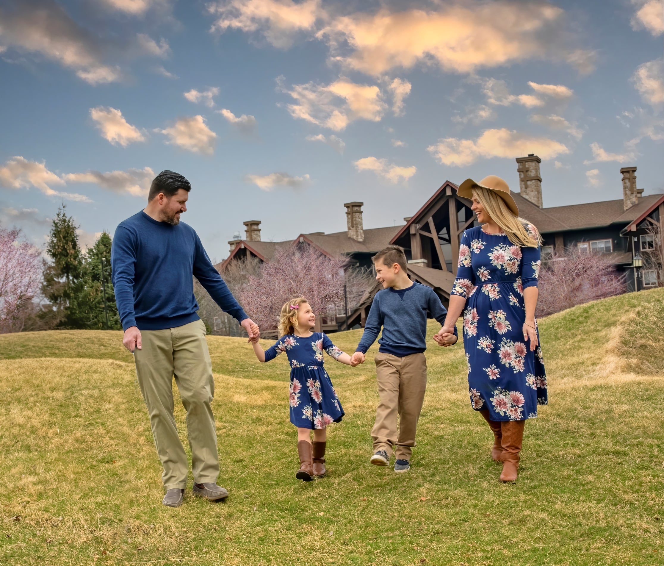 Family of four walking in front of Grand Cascades Lodge