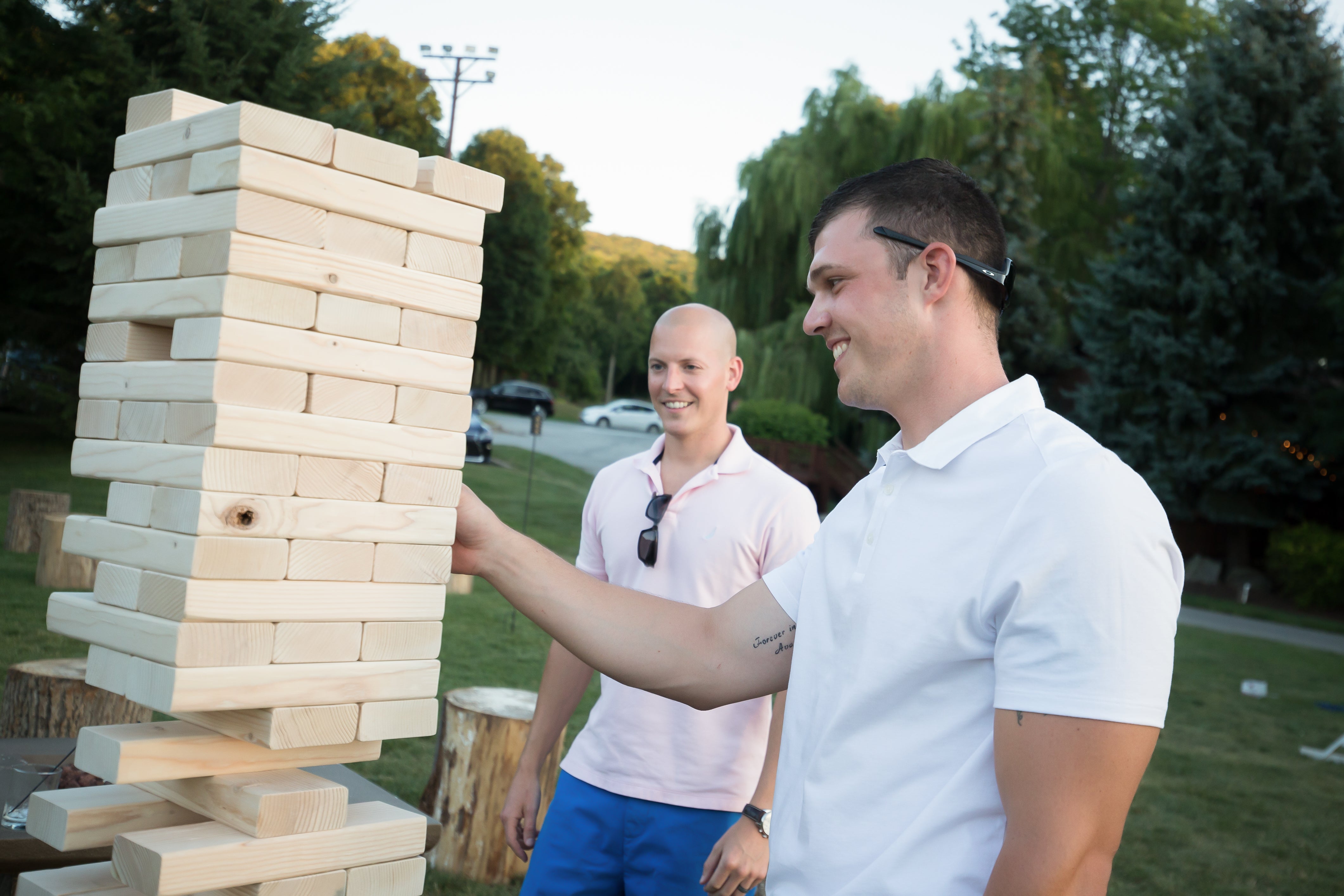 Men playing giant jenga game