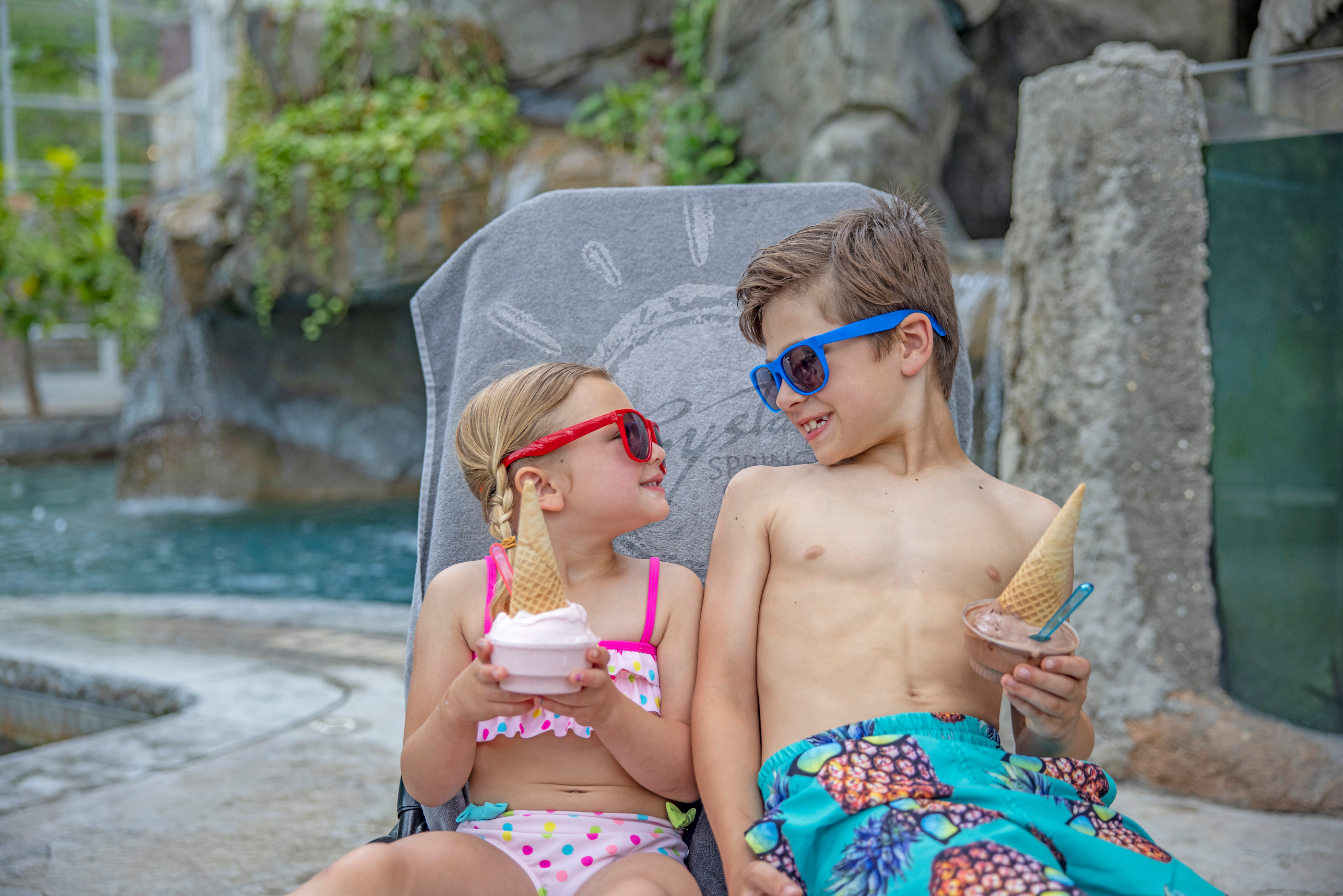 Bother and sister smiling with their ice cream cones by the pool at Crystal Springs Resort in NJ