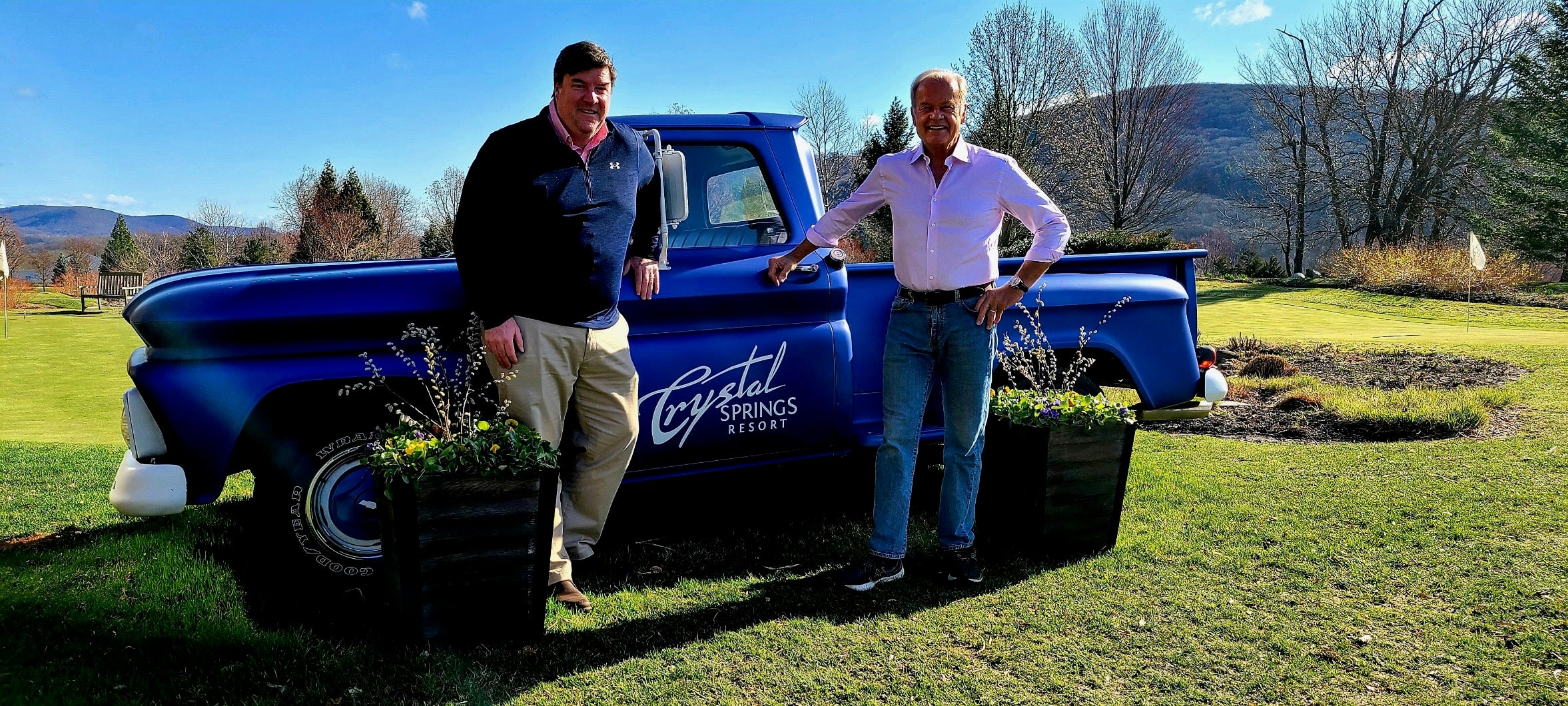 Kelsey Grammer and Chris Mulvihill standing by blue truck.
