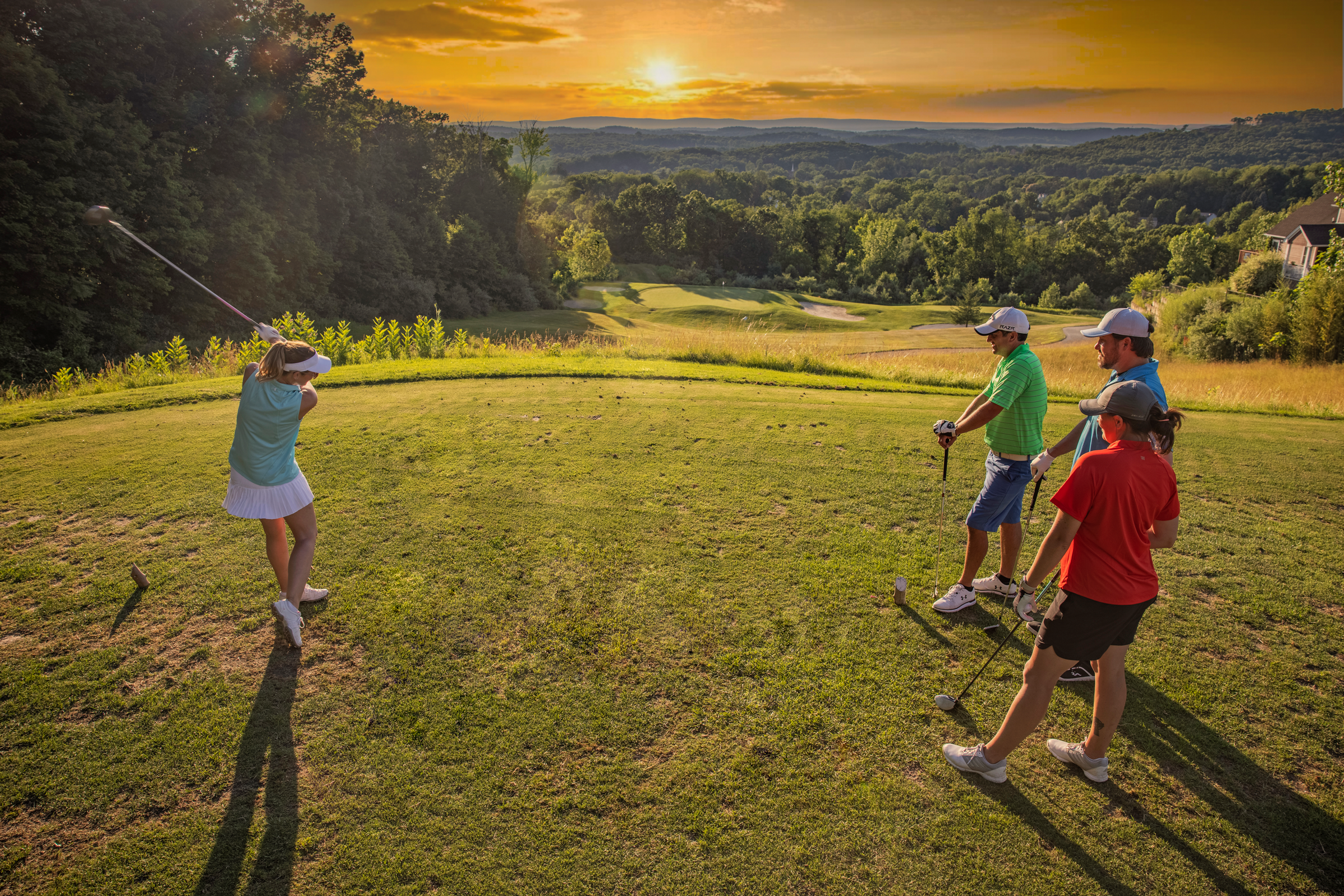Golfers at sunset on the course of Wild Turkey at Crystal Springs Resort