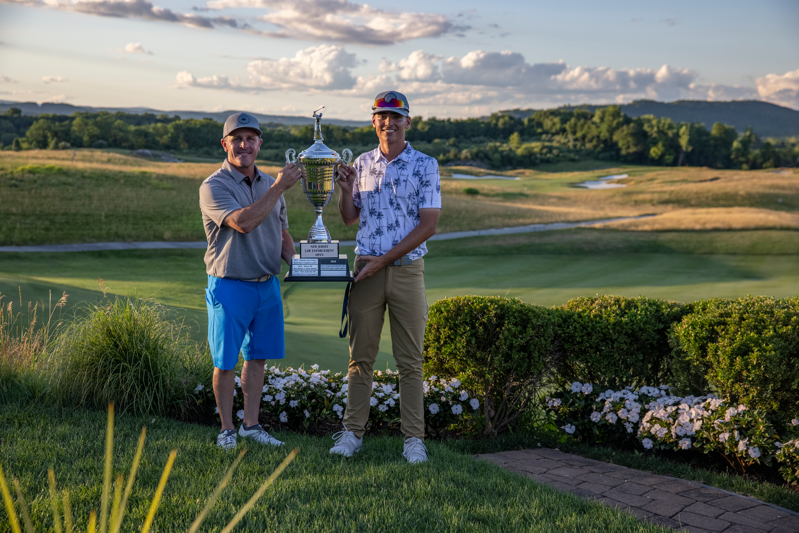 Two winners from the Law Enforcement Open 2022 standing with trophy