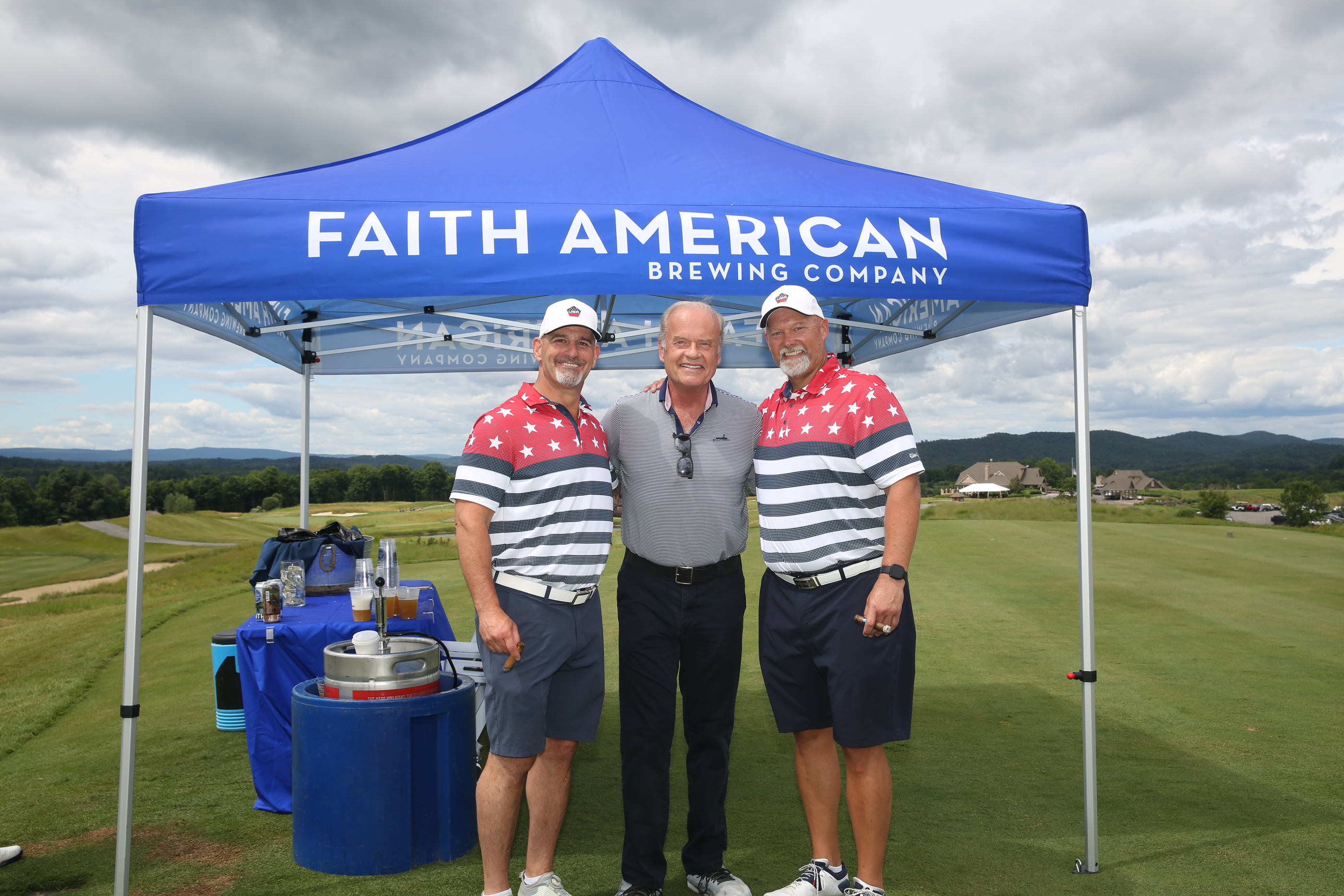 Two golfers standing with Kelsey Grammer