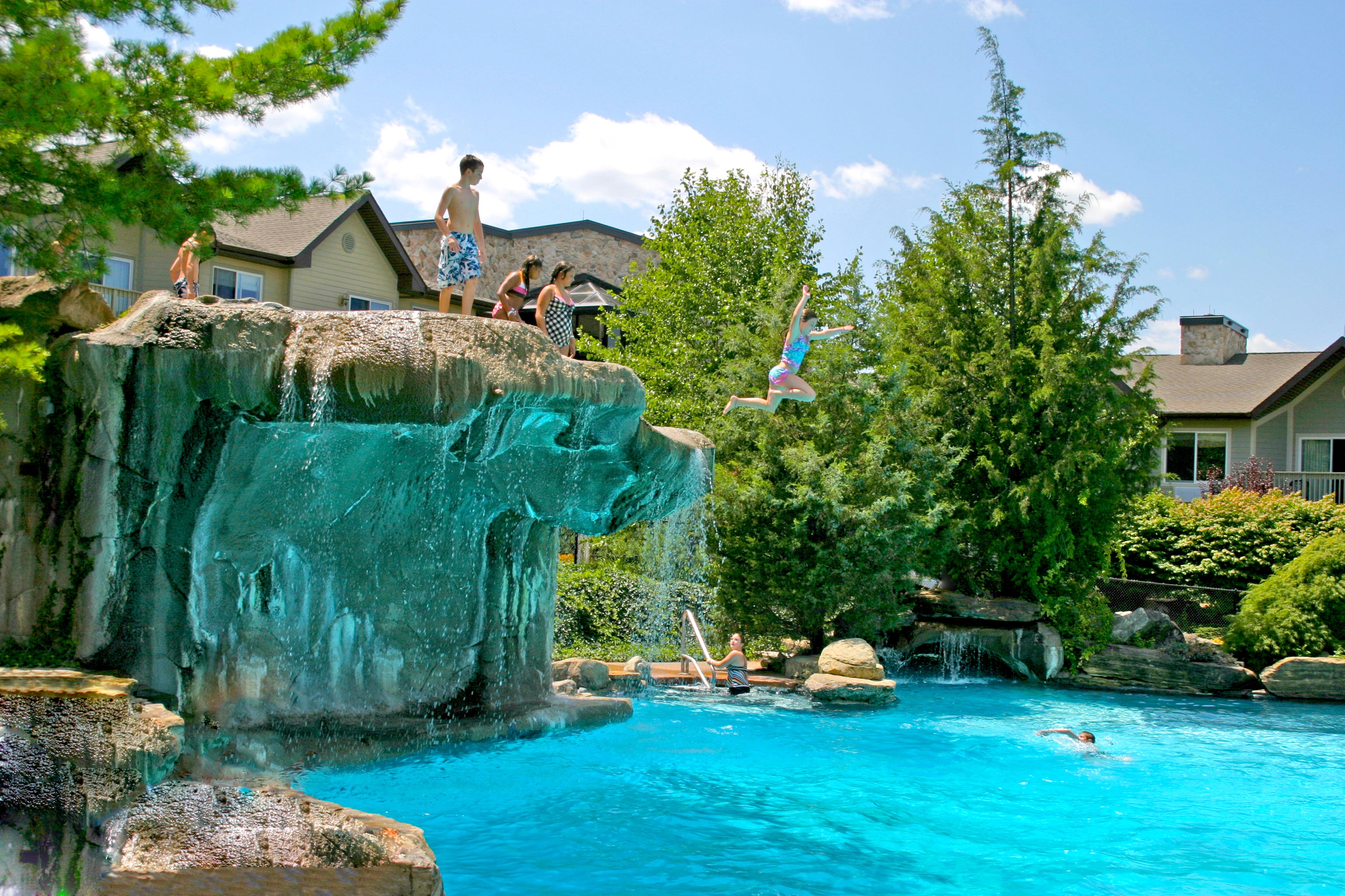 Girl jumping from cliff jump at Minerals Hotel pool