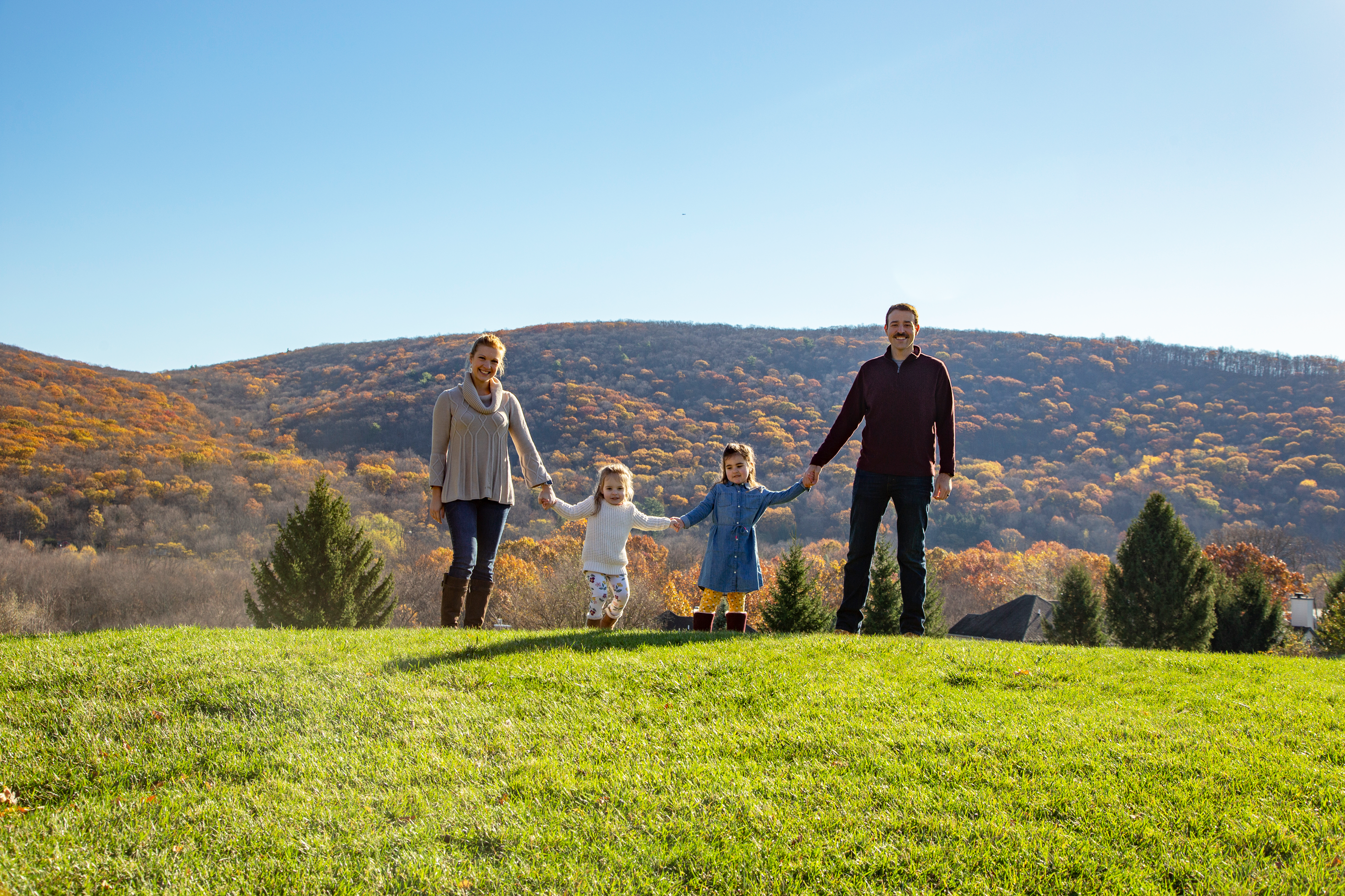 Family holding hands in front of the beautiful mountain view at Crystal Springs Resort