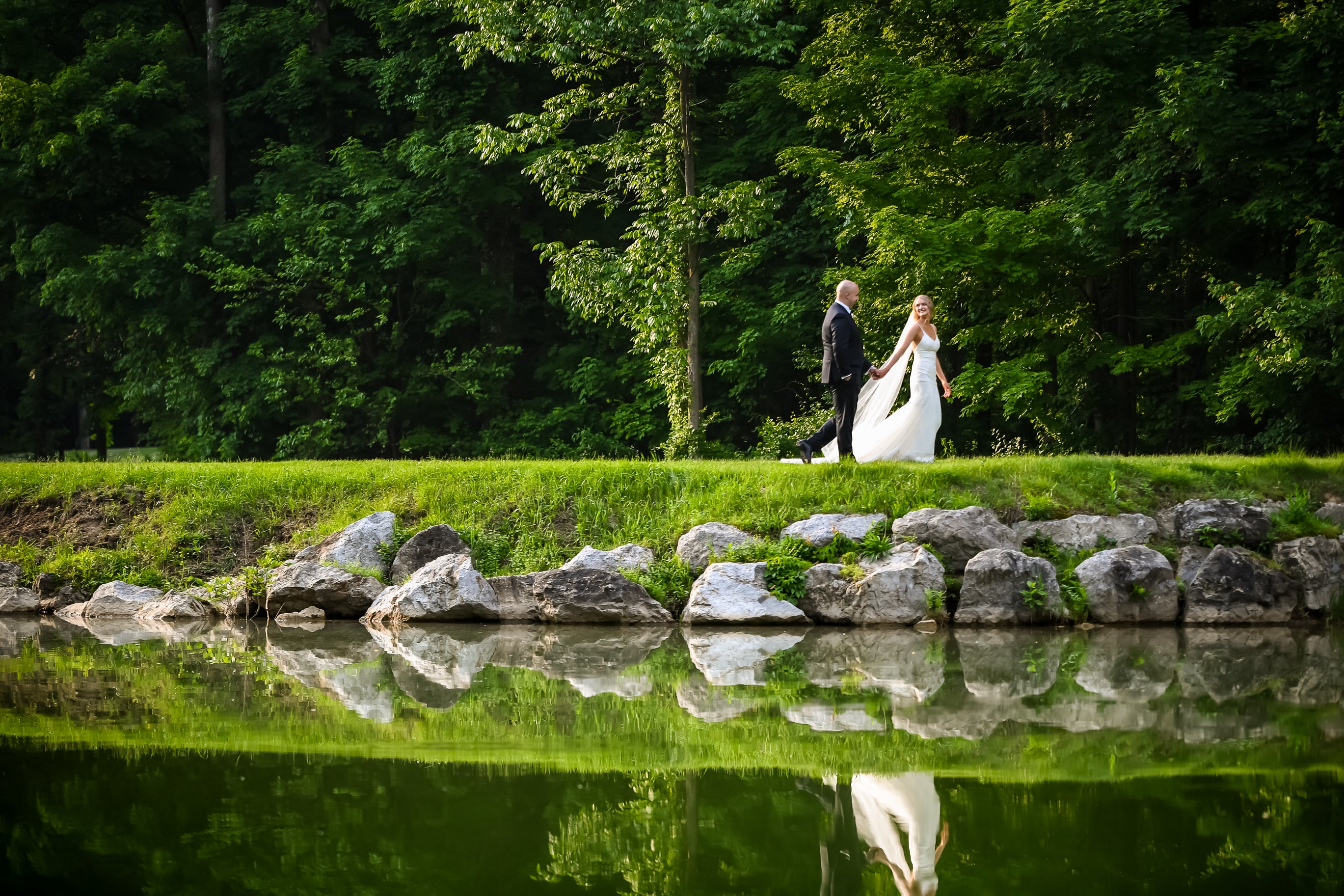 Bride and Groom walking on a golf course.