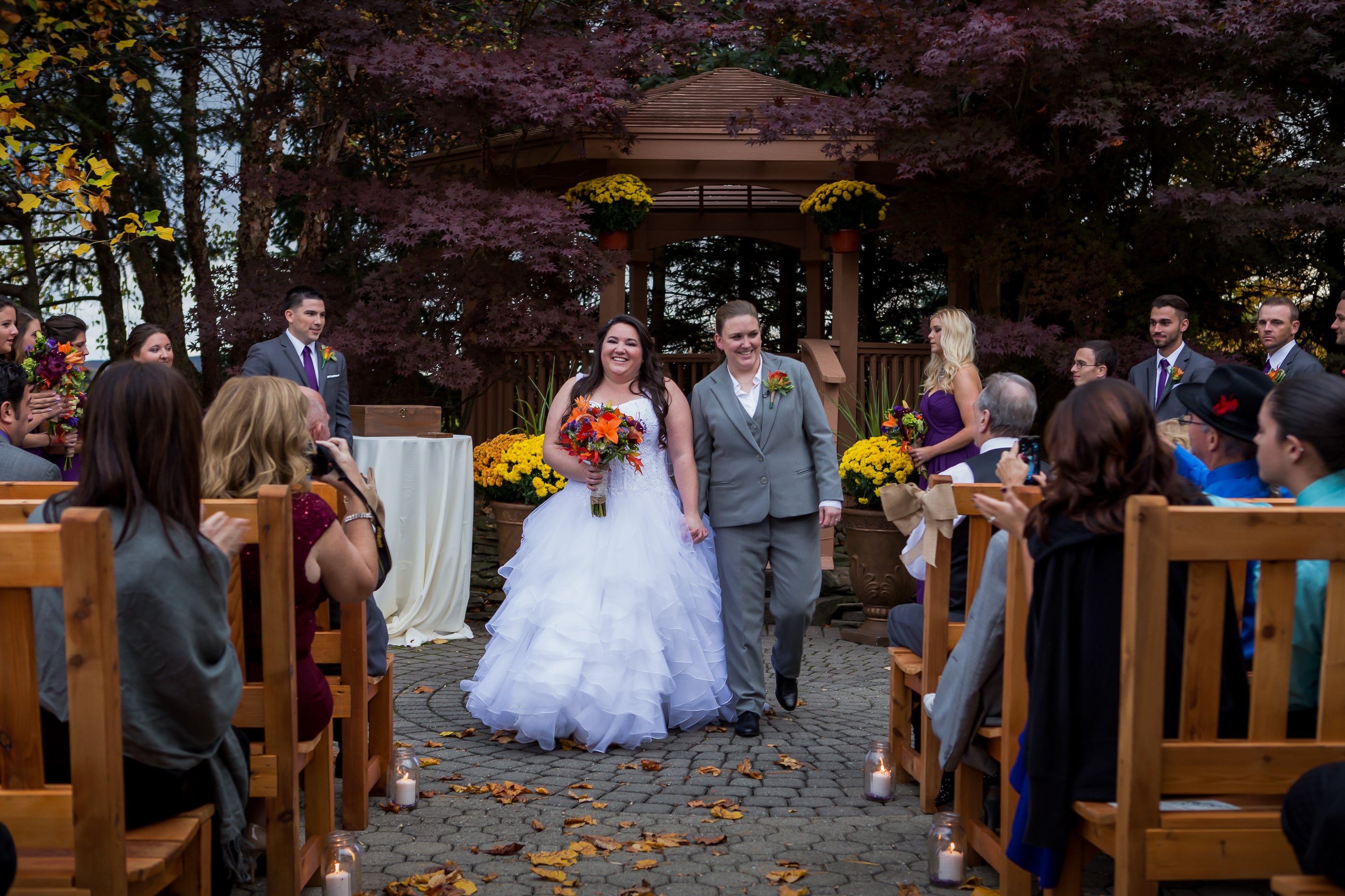 Two ladies just married outside in the fall.