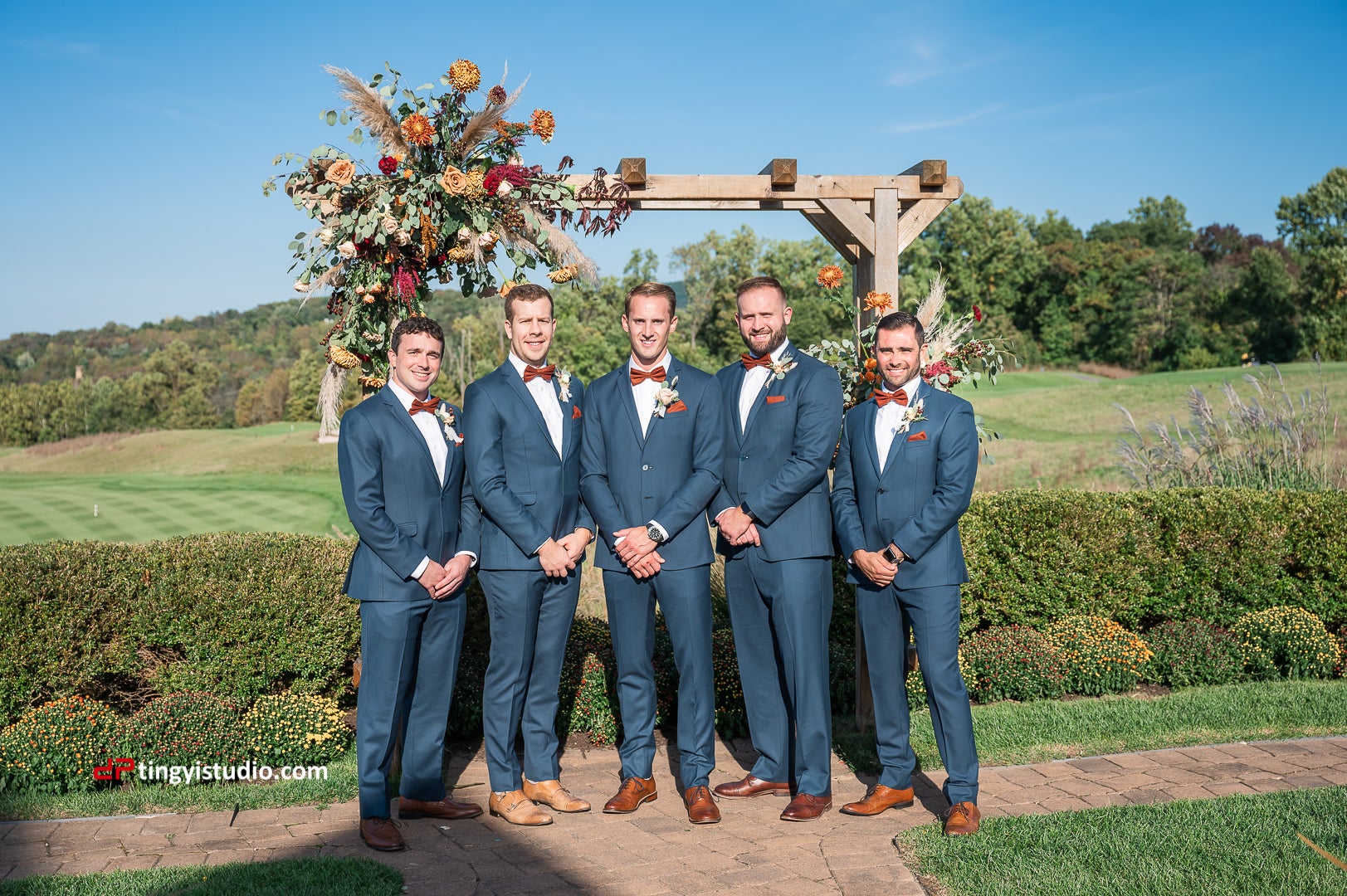Groomsmen standing in front of alter at a golf course venue