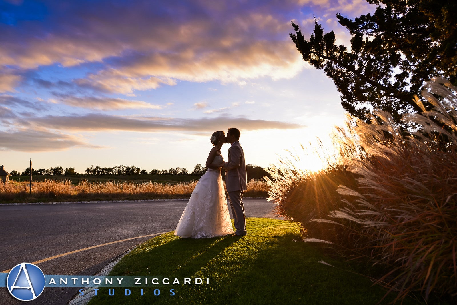 Beautiful wedding couple kissing at sunset