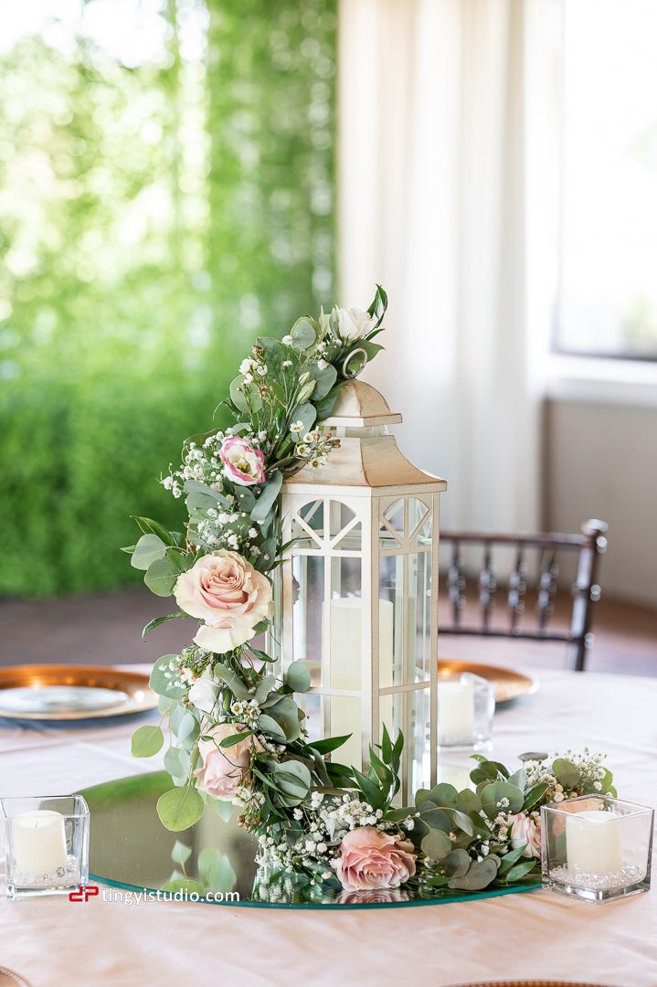 Wedding table centerpiece of flowers wrapped lantern