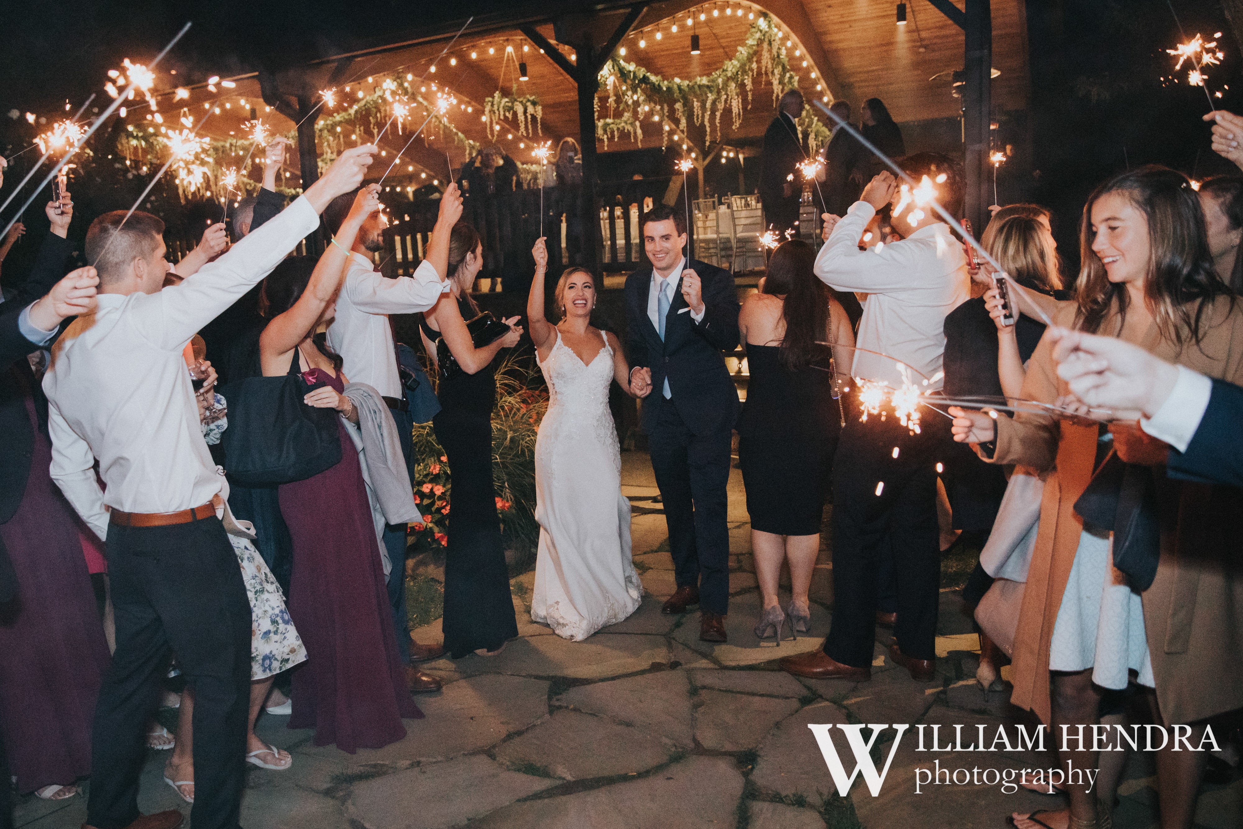 Wedding couple walking through sparklers