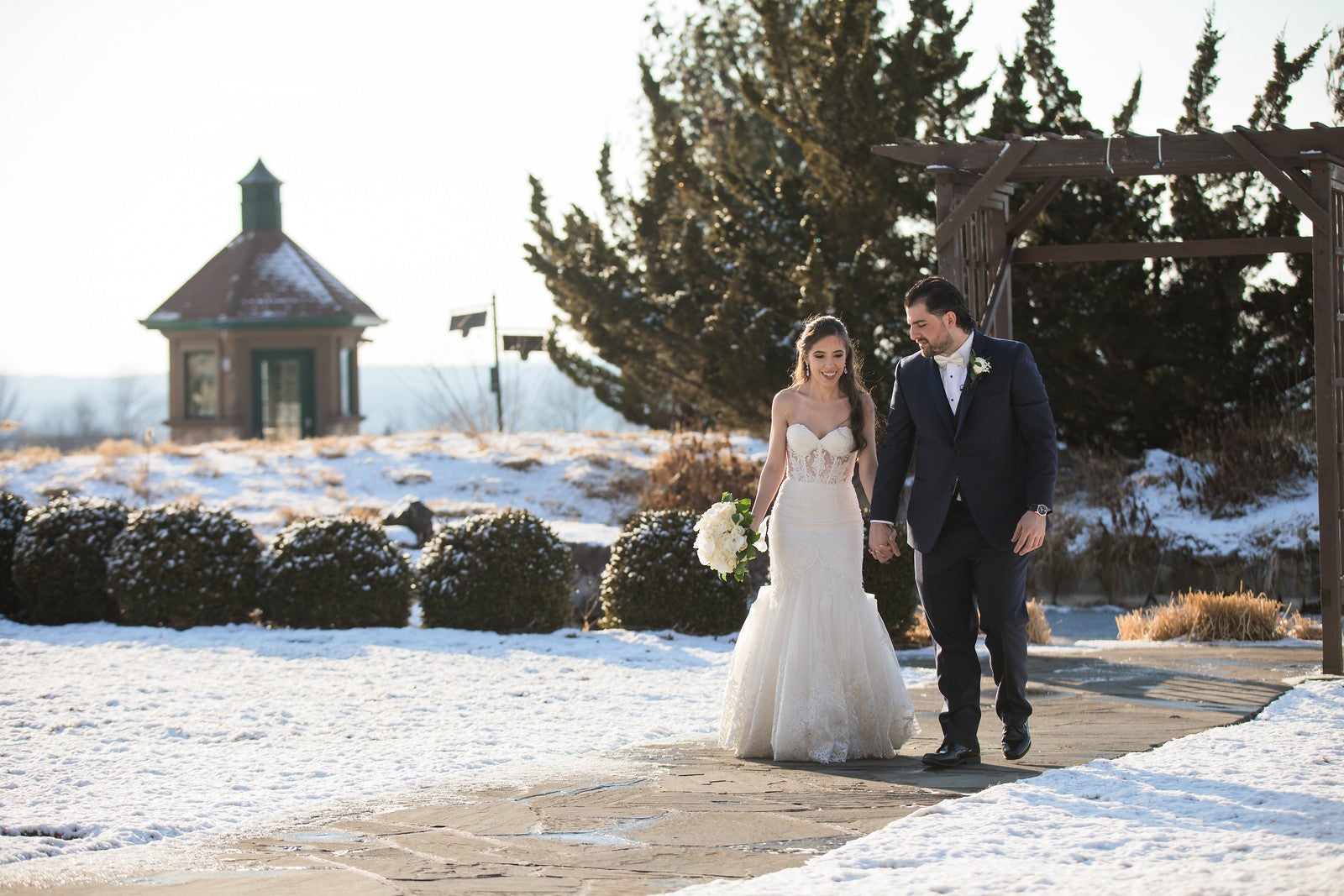 Bride and Groom walking the grounds of Crystal Springs Resort in winter