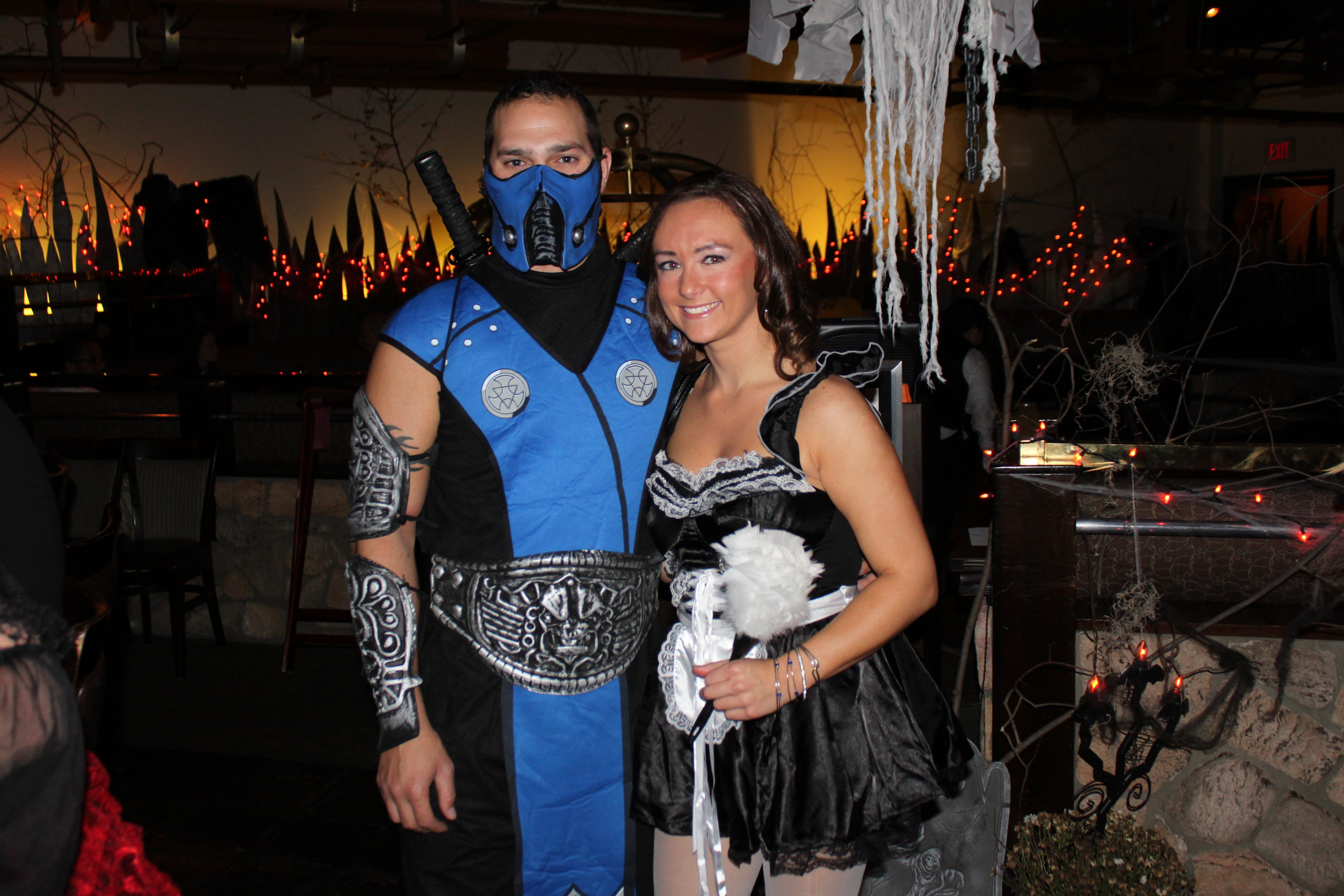 Woman and man dressed up in costumes for halloween.