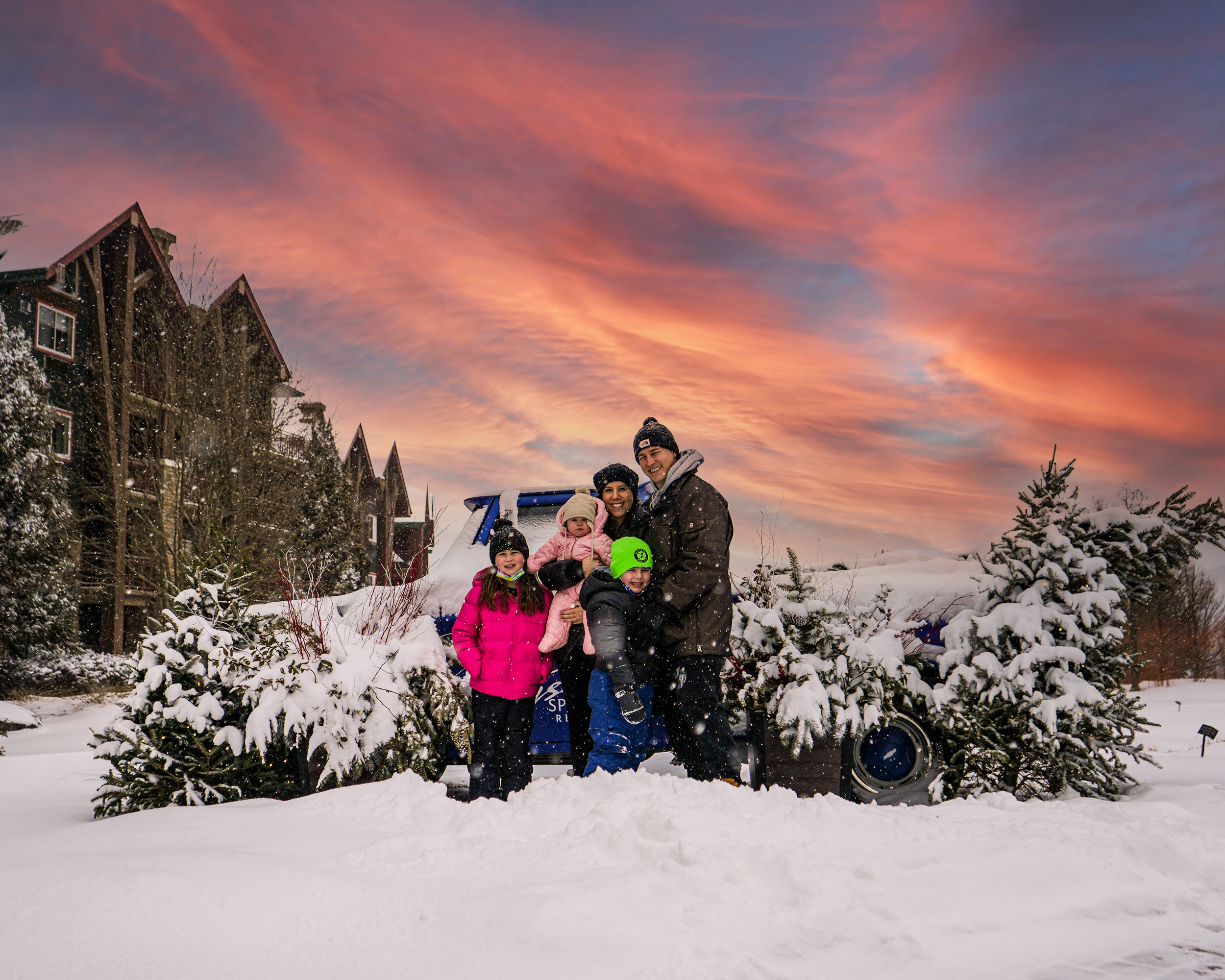 Family enjoying a snowy day at Grand Cascades Lodge