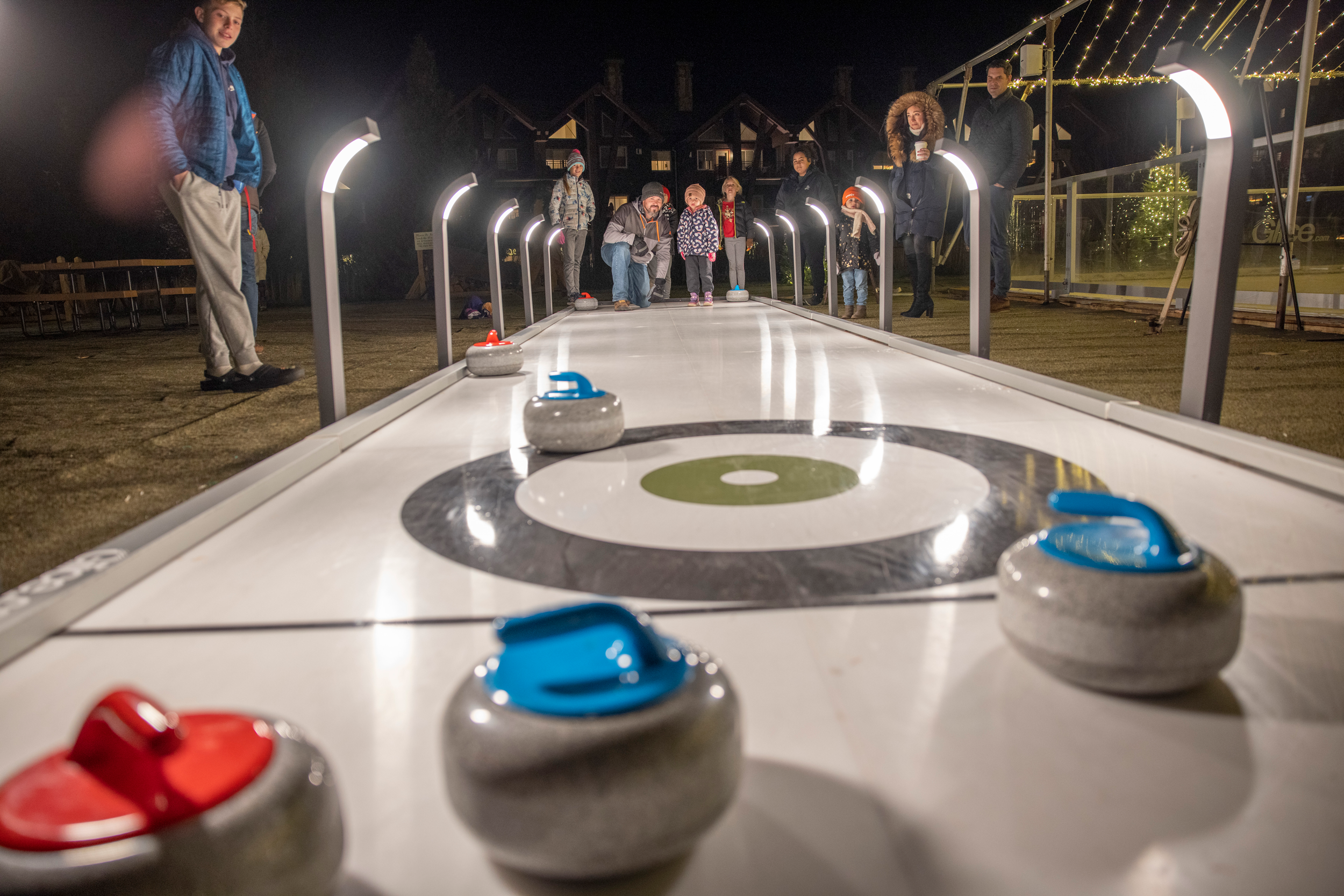 Group of people doing curling at Grand Cascades Lodge