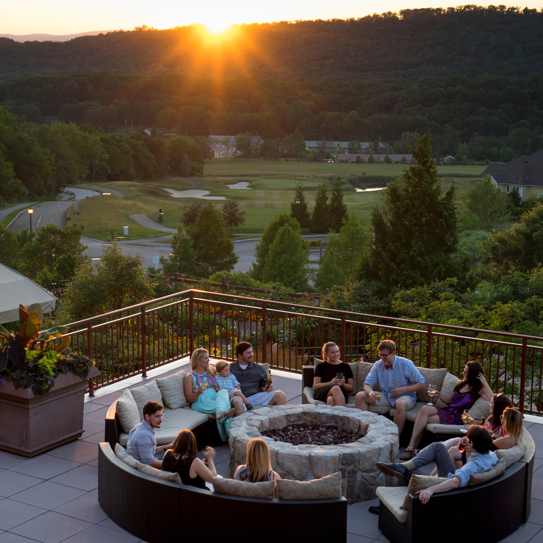 Group hanging out on fire and water terrace at Grand Cascades Lodge