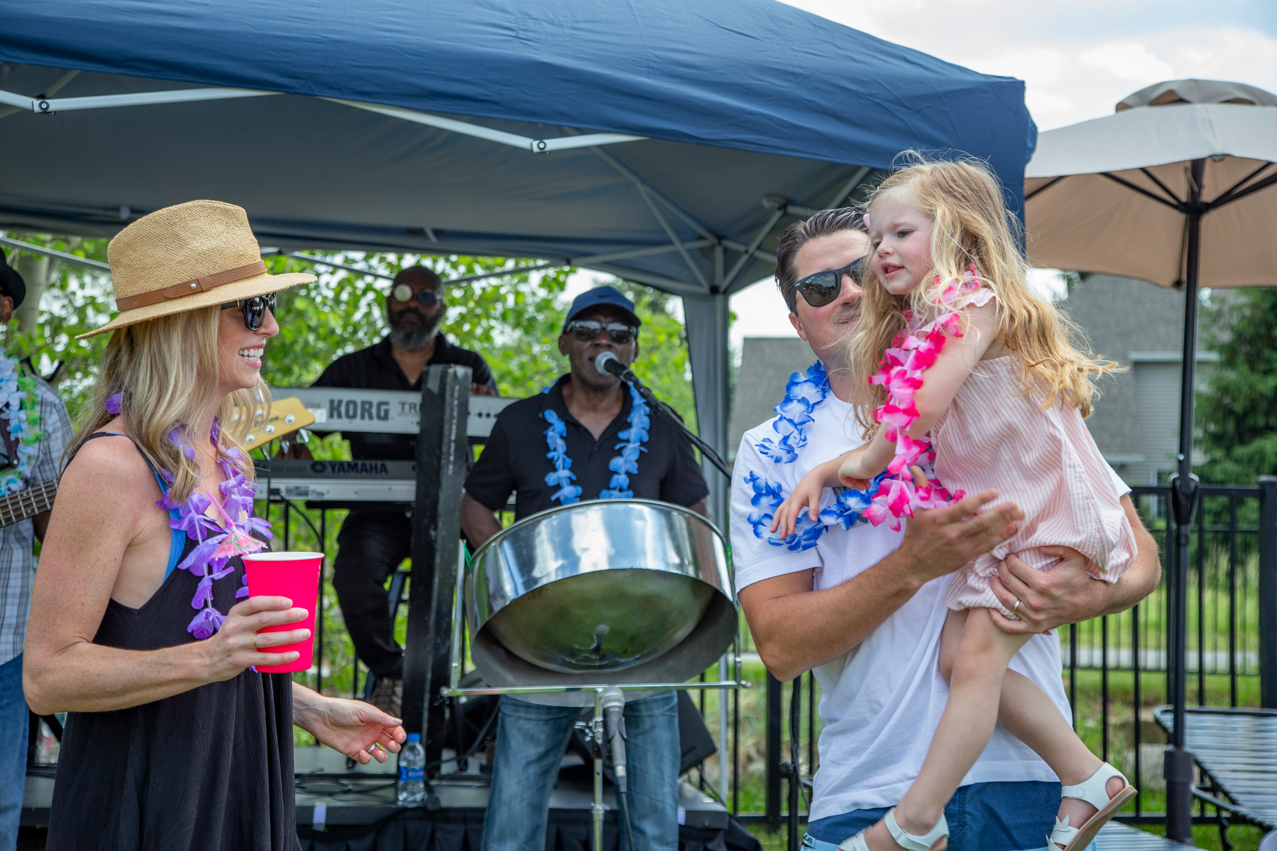 Family dancing to live drum band at Vista Party
