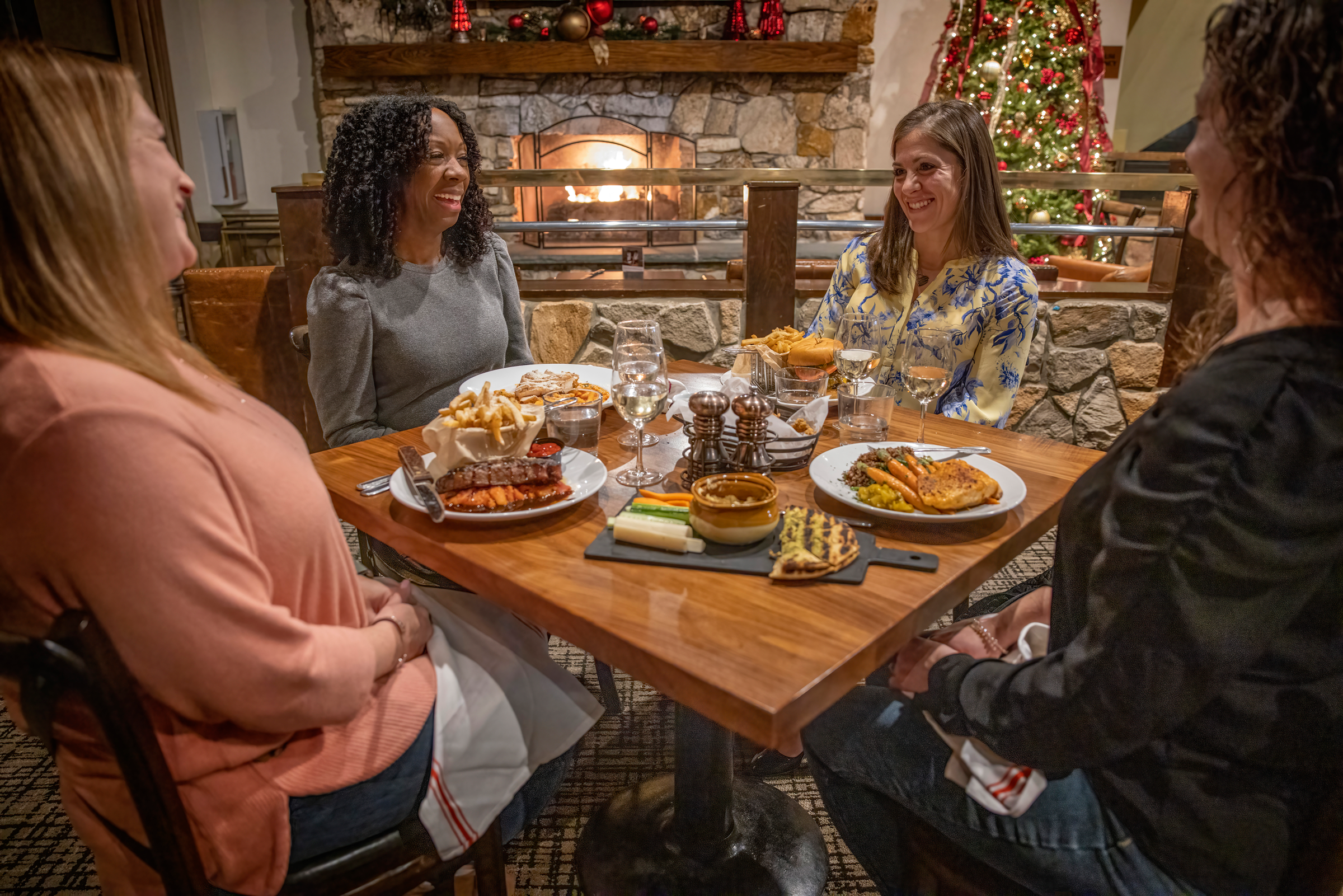 Girlfriends enjoying meal at Kites Restaurant during the Christmas season